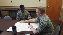 Senior Master Sgt.Robert Demers,(right) 341 Missile Maintenance Squadron facilities flight superintendent, evaluates and provides Senior Airman Trecel Crawford 341st Logistics Readiness Squadron vehicle maintenance journeyman with feedback on enlisted performance reports and future promotion packages during the Pathway to Promotion Program March 17 at Malmstrom Air Force Base, Mont. The program provides Airmen and non-commissioned officers with a one-on-one mock promotion board evaluation. (Courtesy photo)