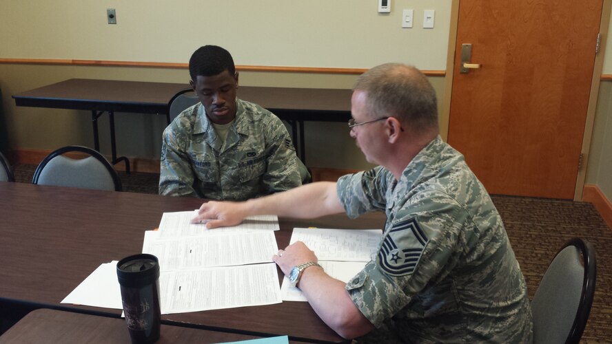 Senior Master Sgt.Robert Demers,(right) 341 Missile Maintenance Squadron facilities flight superintendent, evaluates and provides Senior Airman Trecel Crawford 341st Logistics Readiness Squadron vehicle maintenance journeyman with feedback on enlisted performance reports and future promotion packages during the Pathway to Promotion Program March 17 at Malmstrom Air Force Base, Mont. The program provides Airmen and non-commissioned officers with a one-on-one mock promotion board evaluation. (Courtesy photo)