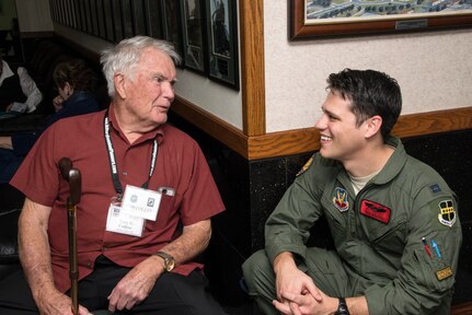 Retired Air Force Lt. Col. Thomas Collins, former Vietnam War POW, speaks with Capt. Benjamin Peacock, 99th Flying Training Squadron pilot training student, during the 560th Flying Training Squadron Artifact Dedication ceremony and open house March 20 at Joint Base San Antonio-Randolph. The annual event, in conjunction with the 42nd Freedom Flyer Reunion and 18th Annual POW/MIA Symposium, honors all POWs held captive during the Vietnam War. The tradition began when the 560th Flying Training Squadron was given the task to retrain more than 150 POWs returning to flying status. Collins aircraft was shot down during a mission over North Vietnam Oct. 18, 1965, and was held captive by the North Vietnamese until his release Feb. 12, 1973. (U.S. Air Force Photo by Johnny Saldivar/released)