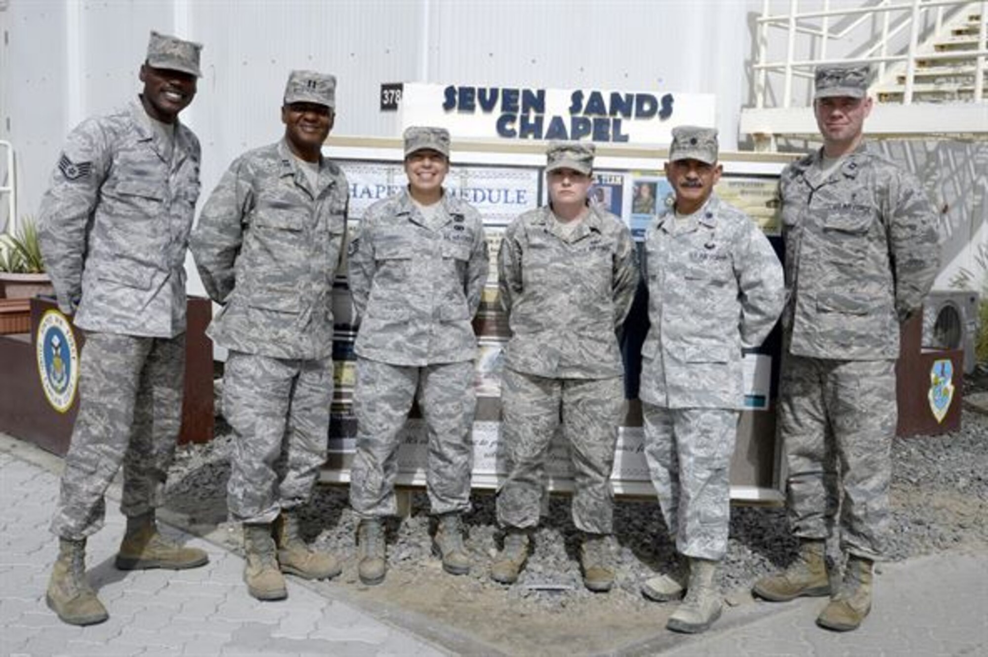 The Seven Sands Chapel staff stands for a photo at an undisclosed location in Southwest Asia Mar. 11, 2015. The wing chapel staff is here to perform and provide decisive spiritual support today and prepare Airmen, Soldiers and civilians to execute always. (U.S. Air Force photo/Tech. Sgt. Marie Brown)
