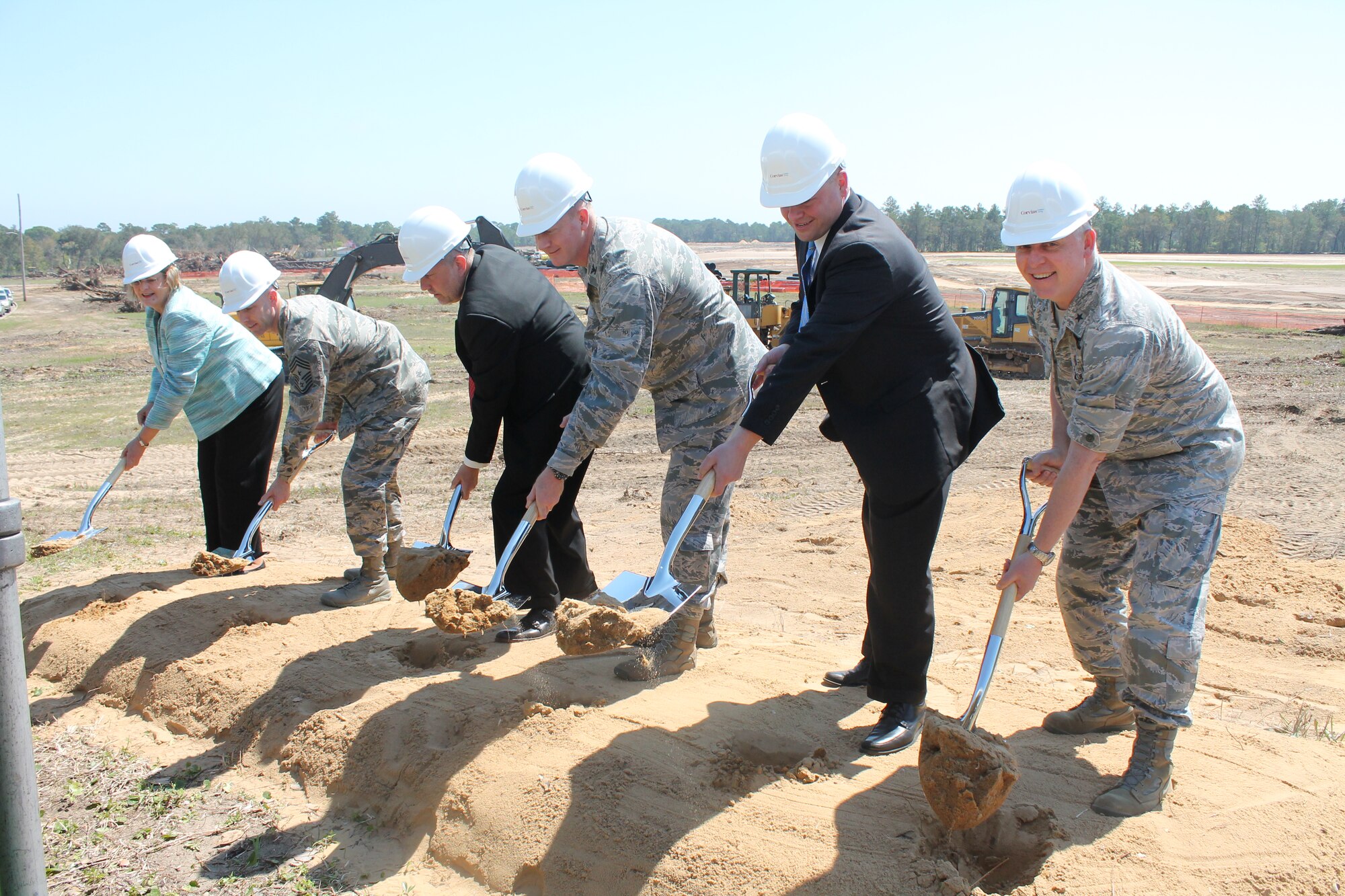 Leadership from Eglin Air Force Base and Corvias Military Living perform the first dig at a groundbreaking ceremony March 20 in the future Plew Landing neighborhood. The ceremony was to mark the start of construction of 747 new homes and a 12,000-square-foot state-of-the-art community center. (Courtesy photo)