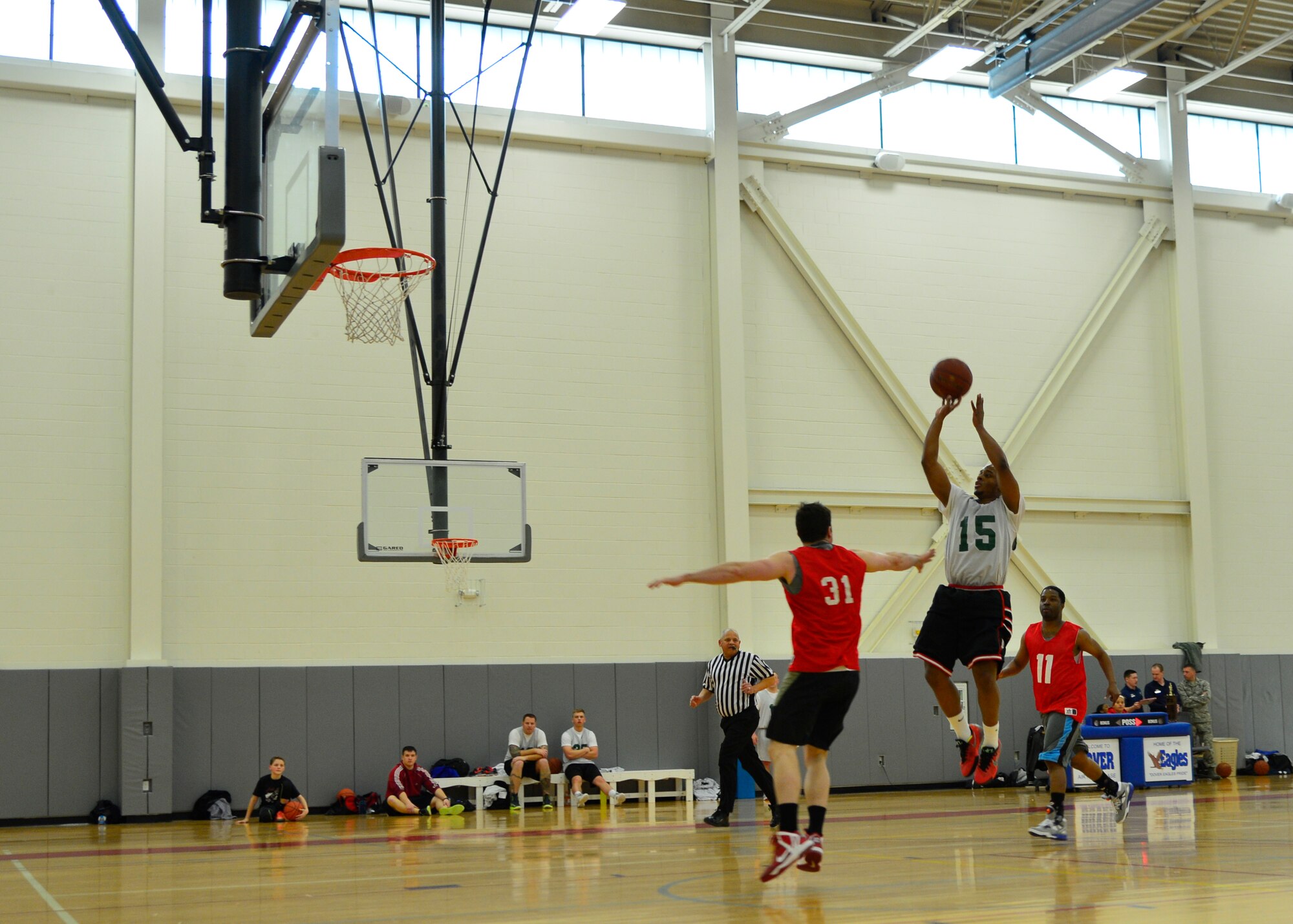 Kenney Roberts, 436th Aerial Port Squadron point guard, shoots a jumper over Eugene Mehaffy, 512th Airlift Wing power forward, in the intramural basketball championship game March 18, 2015, at the fitness center on Dover Air Force Base, Del. For the second consecutive year, the 436th APS fell short losing the championship game, 57-45. (U.S. Air Force photo/Airman 1st Class William Johnson)