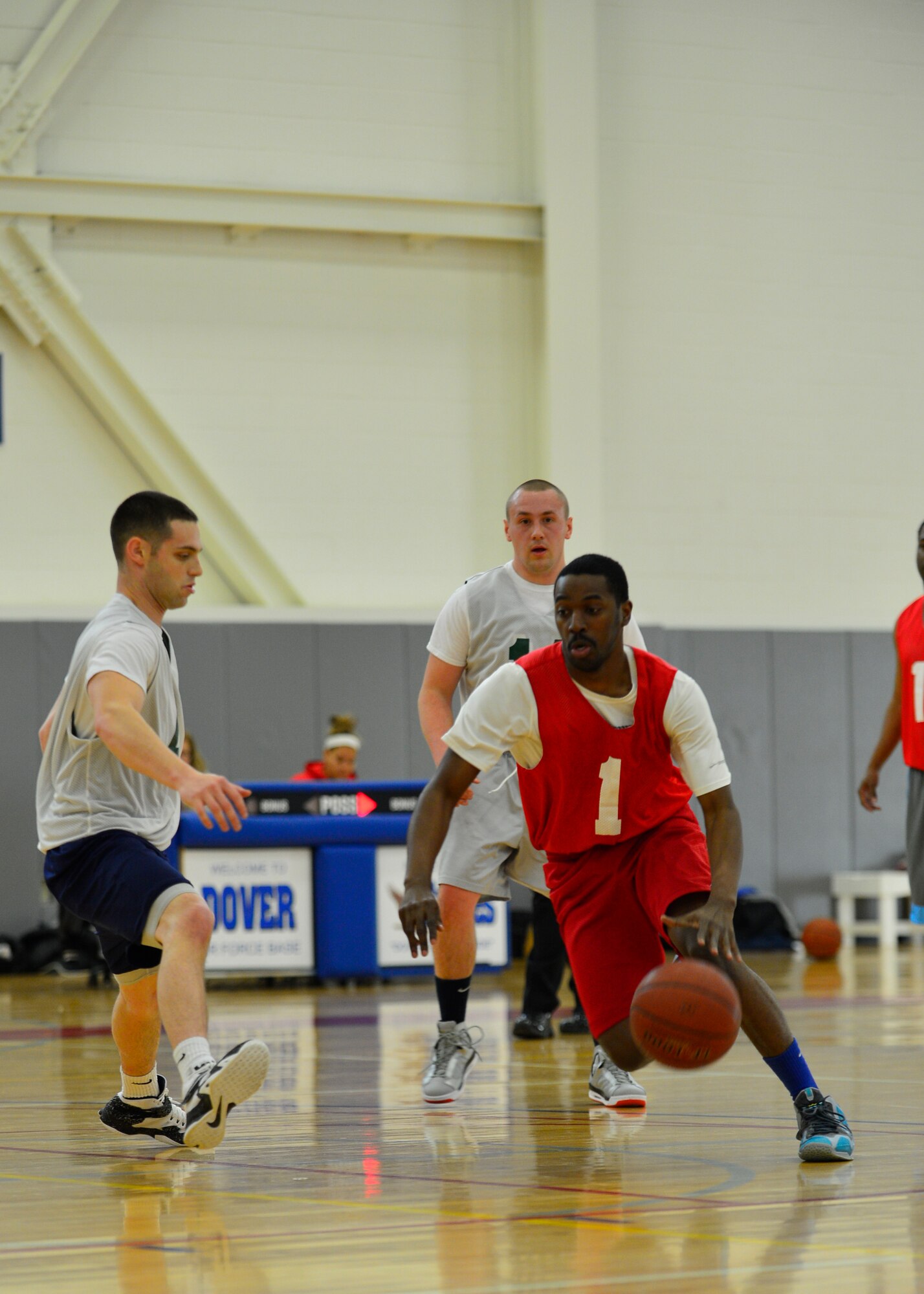 Linwood Reid, 512th Airlift Wing shooting guard, drives past a 436th Aerial Port Squadron defender during the intramural basketball championship game March 18, 2015, at the fitness center on Dover Air Force Base, Del. The 512th defeated the 436th APS, 57-45 to win the base championship. (U.S. Air Force photo/Airman 1st Class William Johnson)