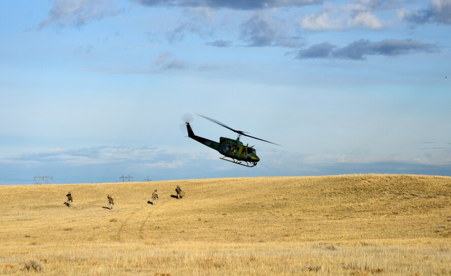 A flight crew from the 40th Helicopter Squadron drops off members of the 341st Security Forces Support Squadron tactical response force team during a simulated a launch facility recapture as part of the Grizzly Rampart training exercise March 18 near Malmstrom Air Force Base. The exercise was implemented to evaluate the readiness of the 341st Missile Wing and ensure first-responder Airmen know and follow the standards set in place for real-world events. (U.S. Air Force photo/Airman 1st Class Collin Schmidt)