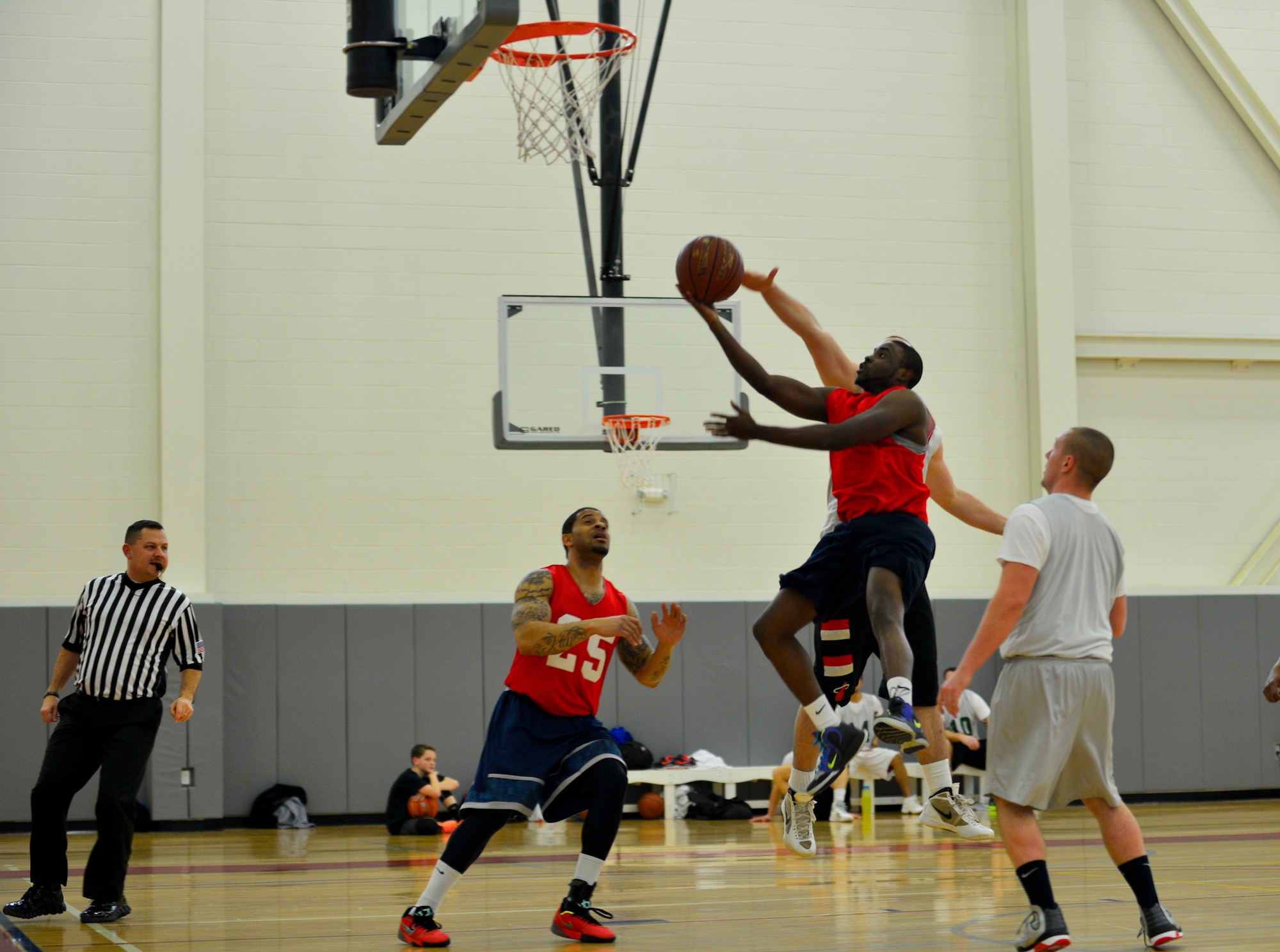 Lateef Shinaba, 512th Airlift Wing point guard, drives in for a lay-up during the intramural basketball championship game against the 436th Aerial Port Squadron March 18, 2015, at the fitness center on Dover Air Force Base, Del. The 512th AW defeated the 436th APS, 57-45 and won their third championship title. (U.S. Air Force photo/Airman 1st Class William Johnson)