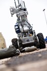 341st Civil Engineer Squadron explosive ordnance disposal team members use a robot to pick up and transport a simulated improvised explosive device as part of the Grizzly Rampart training exercise March 17 at Malmstrom Air Force Base. The exercise was implemented to evaluate the readiness of the 341st Missile Wing and ensure first-responder Airmen know and follow the standards set in place for real-world events. (U.S. Air Force photo/Airman 1st Class Collin Schmidt)