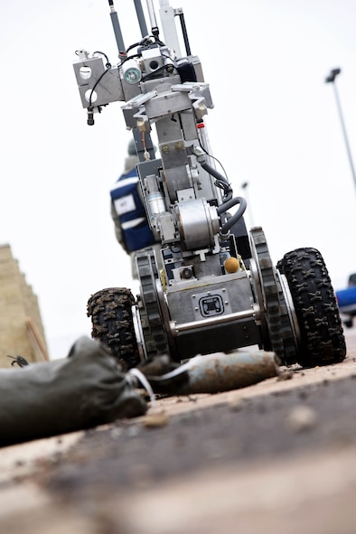 341st Civil Engineer Squadron explosive ordnance disposal team members use a robot to pick up and transport a simulated improvised explosive device as part of the Grizzly Rampart training exercise March 17 at Malmstrom Air Force Base. The exercise was implemented to evaluate the readiness of the 341st Missile Wing and ensure first-responder Airmen know and follow the standards set in place for real-world events. (U.S. Air Force photo/Airman 1st Class Collin Schmidt)