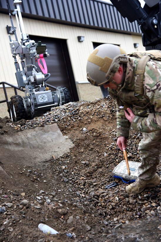 A member of the 341st Civil Engineer Squadron explosive ordnance disposal team probes the ground for simulated unexploded ordnance as part of the Grizzly Rampart training exercise March 17 at Malmstrom Air Force Base. The exercise was implemented to evaluate the readiness of the 341st Missile Wing and ensure first-responder Airmen know and follow the standards set in place for real-world events. (U.S. Air Force photo/Airman 1st Class Collin Schmidt) 