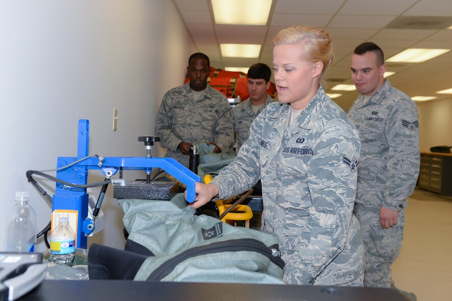 U.S. Air Force Airman 1st Class Jessica Jones, 23d Operations Support Squadron aircrew flight equipment technician, heat seals an OTS 600 dry suit March 19, 2015, at Moody Air Force Base, Ga. Jones heat sealed an inspection tag on a dry suit after it passed a pressure-drop test inspection. (U.S. Air Force photo by Airman Greg Nash/Released)