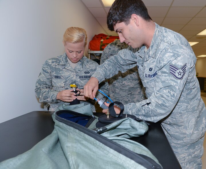 U.S. Air Force Staff Sgt. Kevin Ray, 23d Operations Support Squadron aircrew flight equipment technician, hooks up a water gauge cable to an OTS 600 Dry Suit March 19, 2015, at Moody Air Force Base, Ga. Members from the 23d OSS ensured the dry suit had proper inflation during a pressure-drop test inspection. (U.S. Air Force photo by Airman Greg Nash/Released)