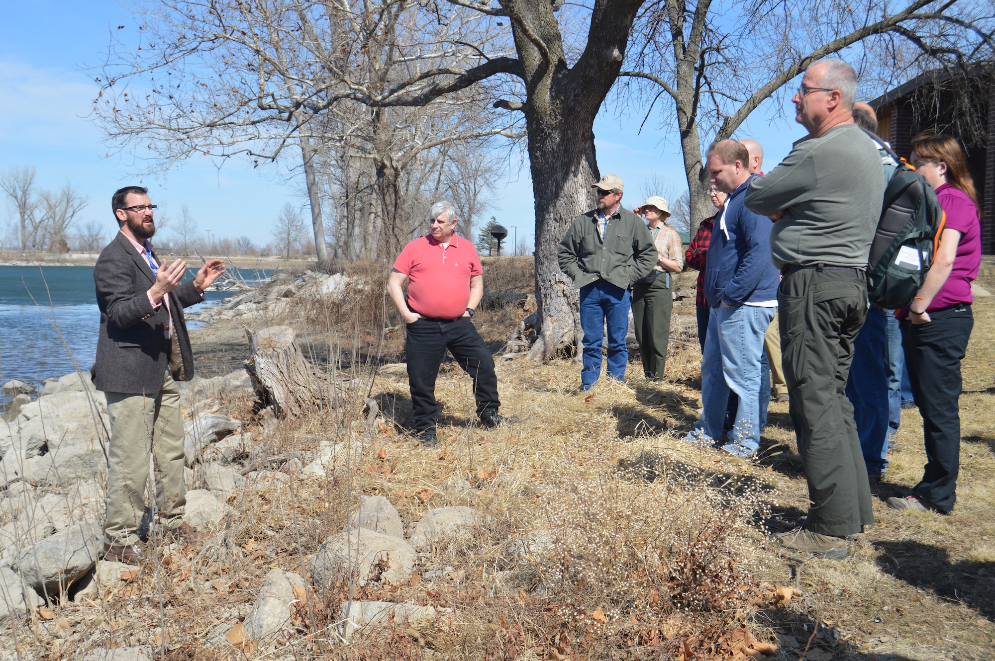 Zach Rigg, a biological scientist, discusses the zebra mussel issue at the base lake, March 13, 2015.  Members of the 55th Civil Engineer Squadron hosted a field trip at the base lake for the 2015 Annual Training Workshop of the National Military Fish & Wildlife Association.  (U.S. Air Force photo by Staff Sgt. Dallas Edwards/Released)