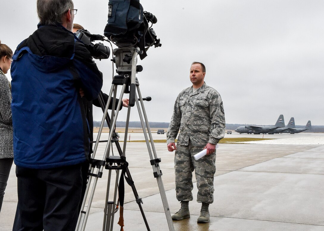 Senior Master Sgt. Kevin Massie, superintendent of the 76th Aerial Port Squadron (APS) here, talks to local media representatives about a Denton cargo mission to Guatemala march 20, 2015. Massie and other Airmen from APS packaged approximately 90 thousand pounds of cargo onto Air Force pallets which were picked up by an aircrew from Dover Air Force Base, Delaware via a C-5 Super Galaxy aircraft. The cargo, which included school supplies, medical items and furniture, was collected by Austintown based Mission of Love charity. U.S. Air Force photo/Eric M. White.