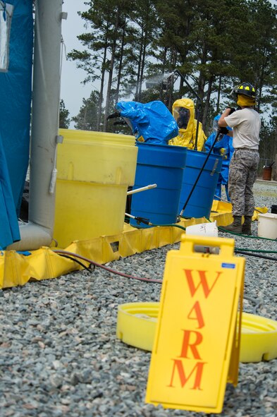 U.S. Air Force Senior Airman Jeremy Hickson, 23d Civil Engineer Squadron emergency management specialist, rinses off after a scenario at an integrated base emergency response capability training March 18, 2015, at Moody Air Force Base, Ga. Scenario participants washed off at the decontamination line to ensure they didn’t come in contact with any hazardous threats. (U.S. Air Force photo by Airman 1st Class Ceaira Tinsley/Released)