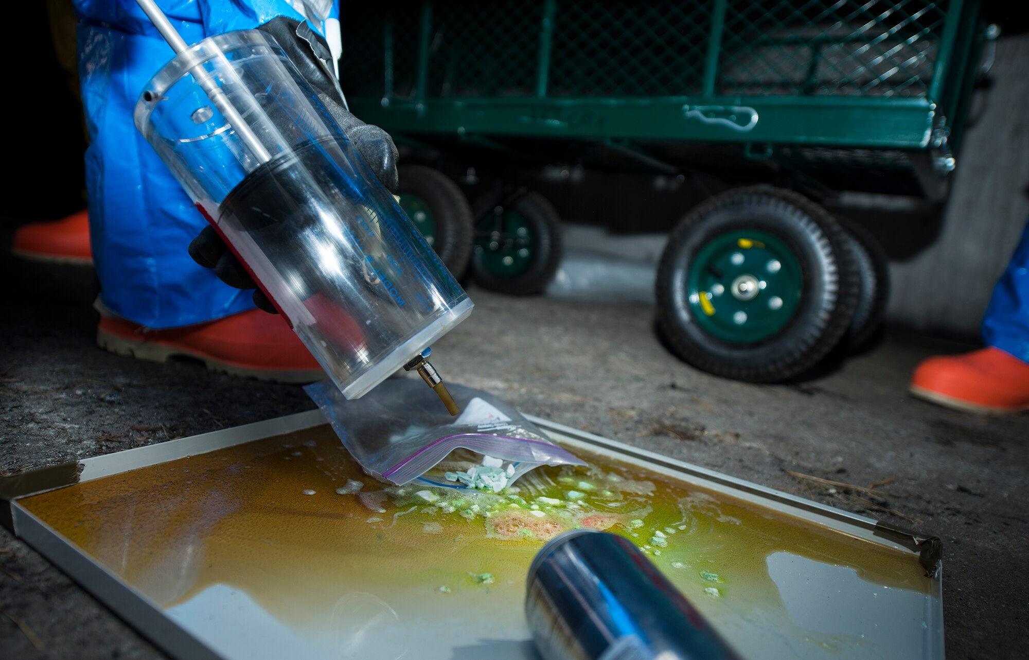 U.S. Air Force Airman 1st Class Matthew Manzano, 23d Medical Group bioenvironmental flight technician, uses a syringe to take samples during an integrated base emergency response capability training March 18, 2015, at Moody Air Force Base, Ga. The bio flight tested the samples for chemicals to identify any potential hazards. (U.S. Air Force photo by Airman 1st Class Ceaira Tinsley/Released)