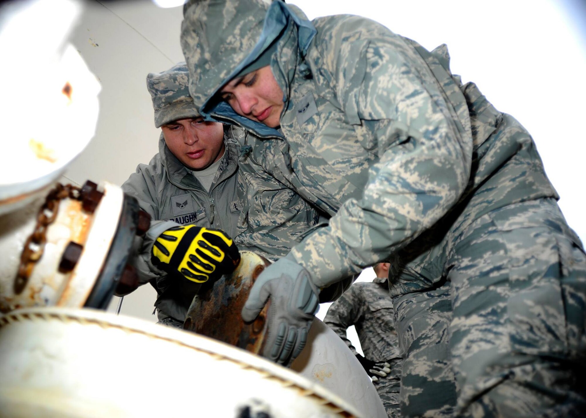 Airman 1st Class Luis Matamoros, right, 931st Civil Engineer Squadron operations water and fuels system journeyman, and Senior Airman Joey Baughn, 22nd CES operations water and fuels system journeyman, remove a blind flange on a Jet-A fuel line, March 19, 2015, at McConnell Air Force Base, Kan. Members of the 931st CES and 22nd CES regularly work together on preventative and reactive maintenance to keep the base infrastructure in top shape. (U.S. Air Force photo by Senior Airman Victor J. Caputo)