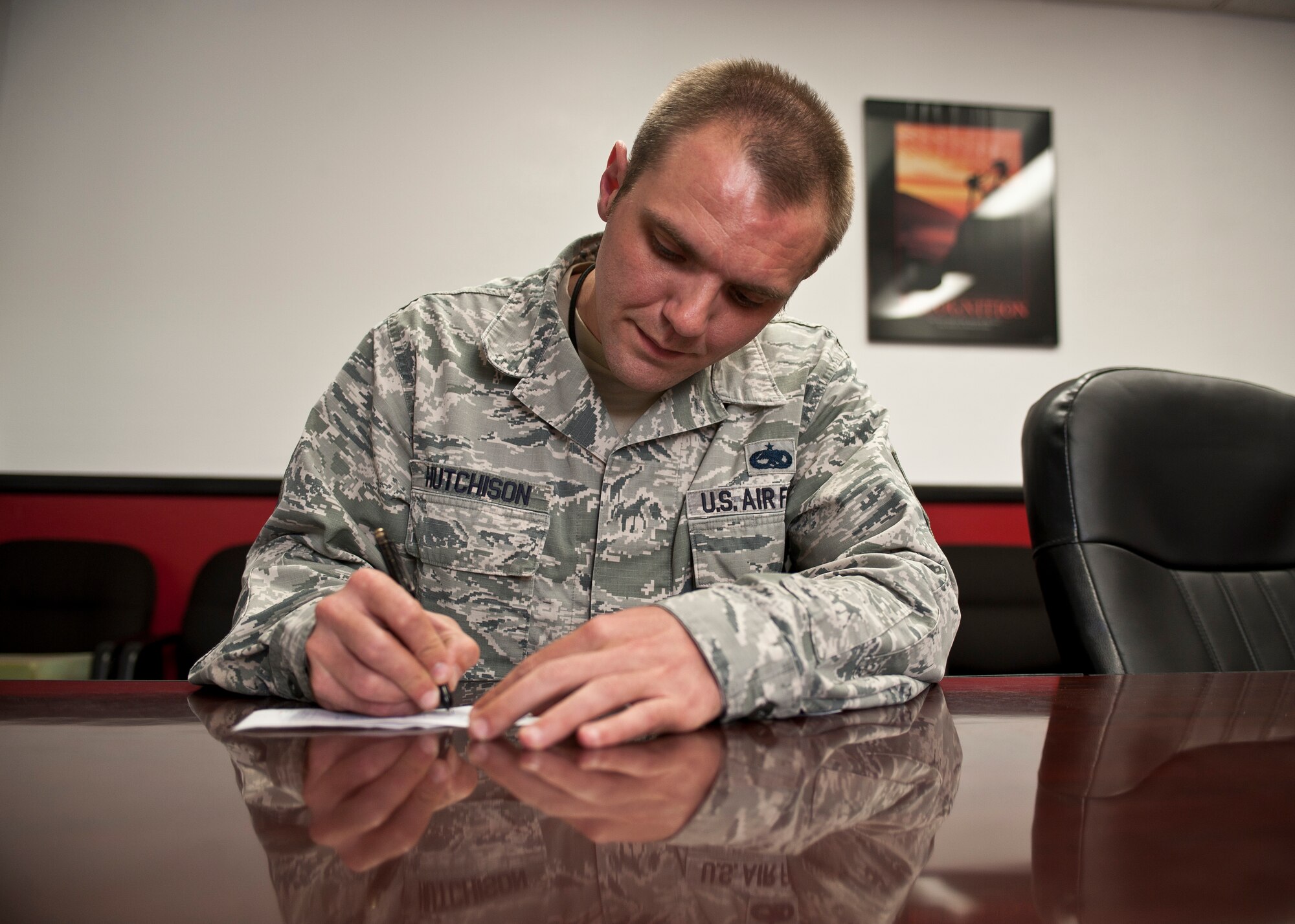 Master Sgt. Dennis Hutchison, 57th Aircraft Maintenance Squadron Tomahawks Aircraft Maintenance Unit production superintendent, fills out a pledge form for the 2015 Air Force Assistance Fund drive at Nellis Air Force Base, Nev., March 17, 2015. Hutchison’s father passed away in 2005 and he did not have enough money to travel to his hometown in Missouri from his assigned duty station in Georgia, but received an interest-free loan from the Air Force Aid Society to cover his travel costs. Now an avid supporter of the AFAF, which supports and funds four different charities including the AFAS, Hutchison encourages Airmen of all ranks and ages to donate to the AFAF drive. (U.S. Air Force photo by Staff Sgt. Siuta B. Ika)