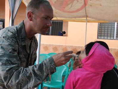 Chaplain Samuel McClellan provides medicine to a local Honduran child during a Medical Readiness Training Exercise, March 11-15, 2015. Joint Task Force-Bravo's Medical Element (MEDEL), with support from JTF-Bravo’s Joint Security Forces and Army Forces Battalion, partnered with the Honduran Ministry of Health and the Honduran military to provide medical care to 5,352 people and performed 11 surgeries over three days in the Department of Copan and Lempira, Honduras during a Mobile Surgical Team (MST), Medical Readiness Training Exercise (MEDRETE), and a Medical Partnership Exercise (MPE). (Photo by U.S. Army Sgt. Stephanie Tucker)