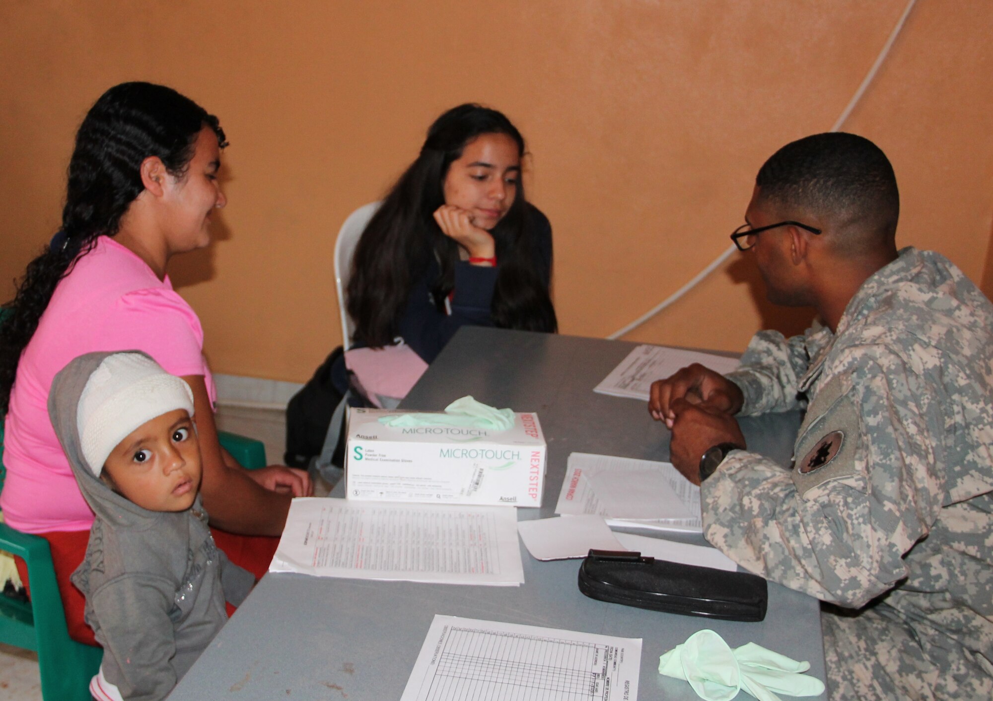 A woman and her child are prescreened by Joint Task Force-Bravo Medical Element technicians during a Medical Readiness Training Exercise, March 11-15, 2015. Joint Task Force-Bravo's Medical Element (MEDEL), with support from JTF-Bravo’s Joint Security Forces and Army Forces Battalion, partnered with the Honduran Ministry of Health and the Honduran military to provide medical care to 5,352 people and performed 11 surgeries over three days in the Department of Copan and Lempira, Honduras during a Mobile Surgical Team (MST), Medical Readiness Training Exercise (MEDRETE), and a Medical Partnership Exercise (MPE). (Photo by U.S. Army Sgt. Stephanie Tucker)