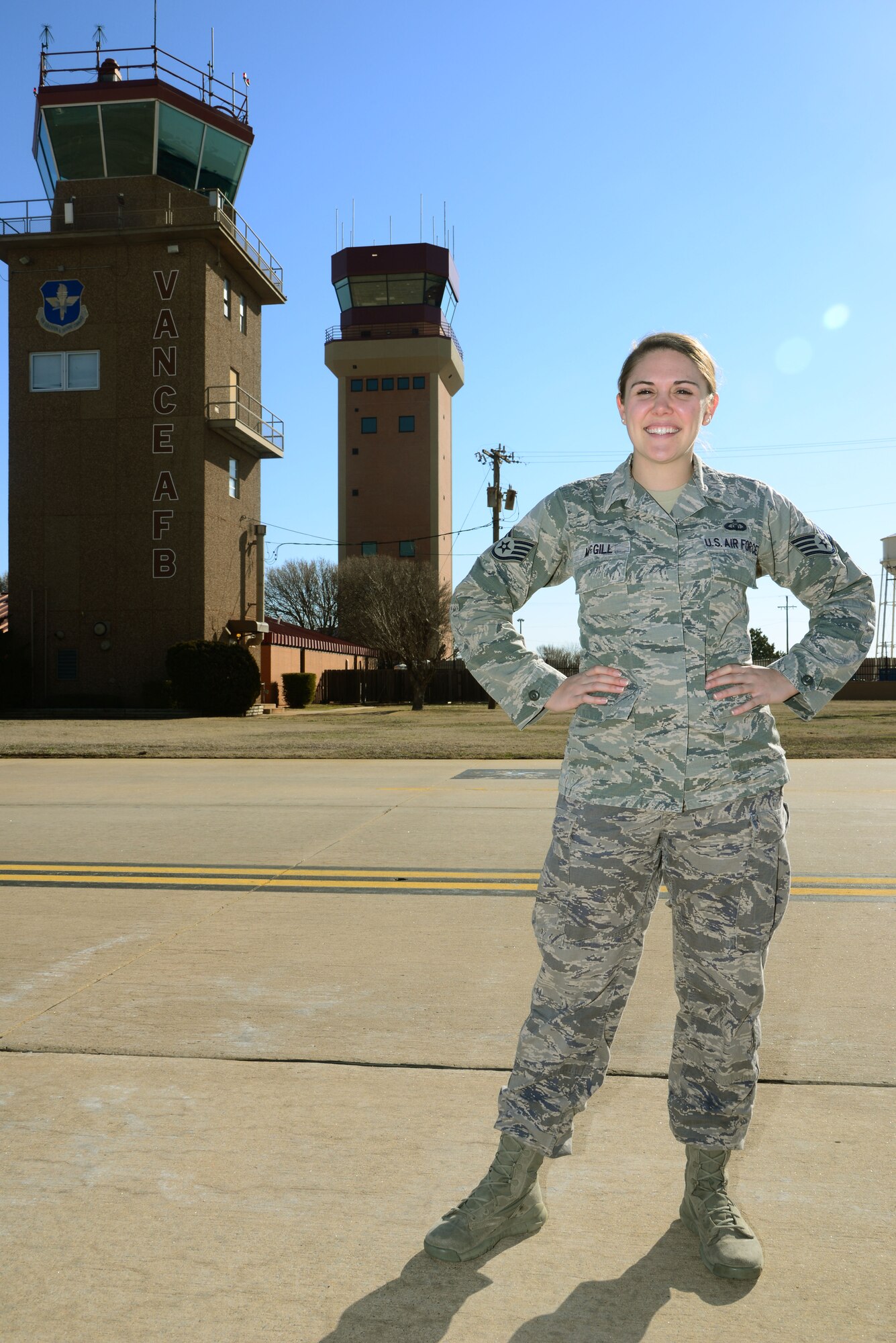 VANCE AIR FORCE BASE, Okla. -- Staff Sgt. Ashley McGill, a 71st Operations Support Squadron air traffic controller, stands outside the air traffic control tower on the flight line, March 11. McGill is the Air Education and Training Command Air Traffic Control Controller of the Year for 2014. (U.S. Air Force photo / Senior Airman Frank Casciotta)