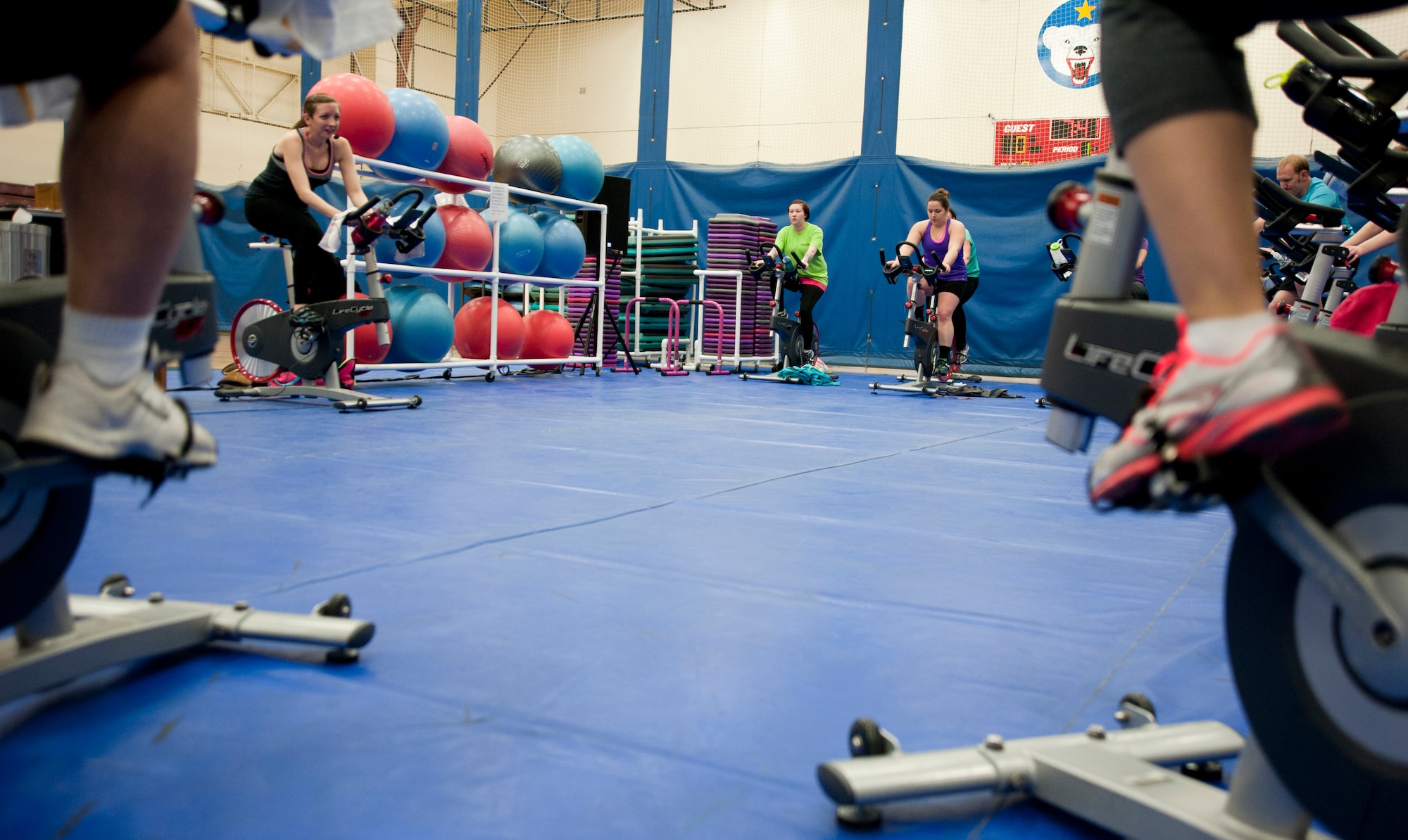 Service members and family members participate in a spin class on Joint Base Elmendorf-Richardson, Alaska, March 10, 2015. Spin class helps individuals who are trying to increase their cardio endurance, burn calories, tone their muscles and relieve stress. The class is offered at both the Buckner Physical Fitness Center and Elmendorf Fitness Center throughout the week. (U.S. Air Force photo/Airman 1st Class Tammie Ramsouer)