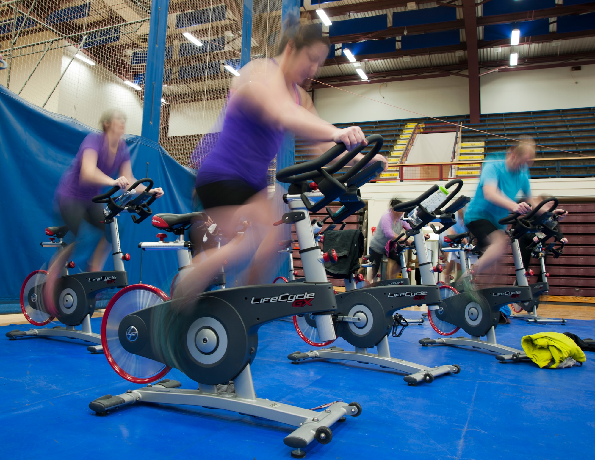 Service members and family members participate during a spin class on Joint Base Elmendorf-Richardson, Alaska, March 10, 2015. Both the Buckner Physical Fitness Center and Elmendorf Fitness Centers provide all JBER’s patrons the opportunity to partake in morning, afternoon and weekend classes, such as spin class, Insanity and Zumba. (U.S. Air Force photo/ Airman 1st Class Tammie Ramsouer)