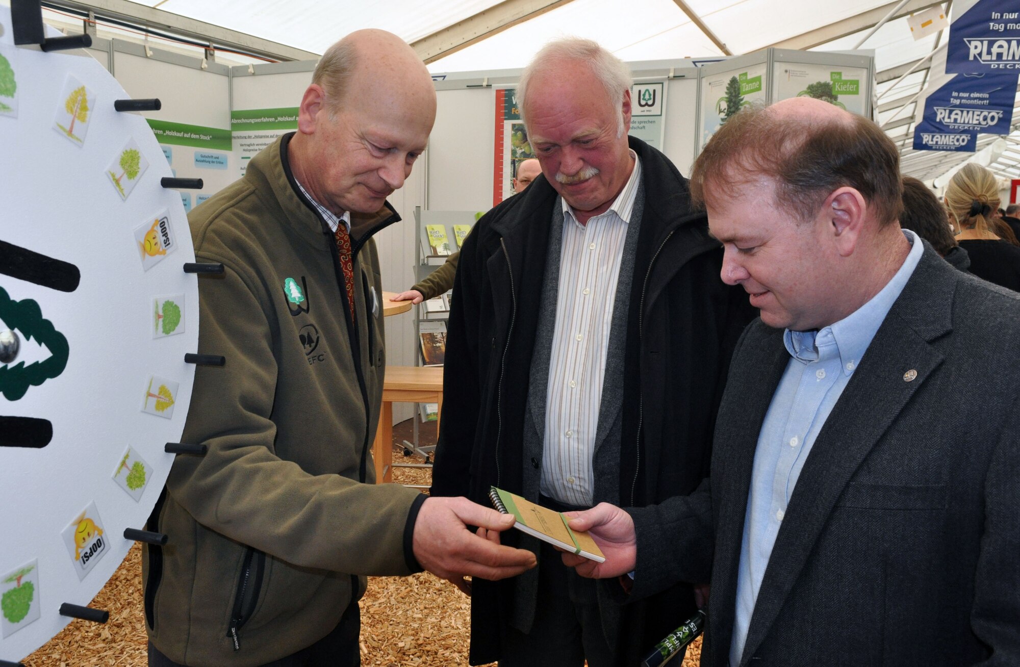 U.S. Air Force Col. Lars Hubert, 52nd Fighter Wing vice commander, right, receives a prize from Graf Ferdinand von Westerholt, owner of Schloss Hamm Castle and representative of a local forest association, left, as Horst Buettner, a former mayor of the city of Bitburg, center, looks on during the opening of this year’s Bitburg Beda market at Bitburg, Germany, March 20, 2015. The Beda Market is a community-wide event where more than 100 local businesses present their products and services at the exhibition tents and elsewhere. (U.S. Air Force photo by Iris Reiff/Released) 