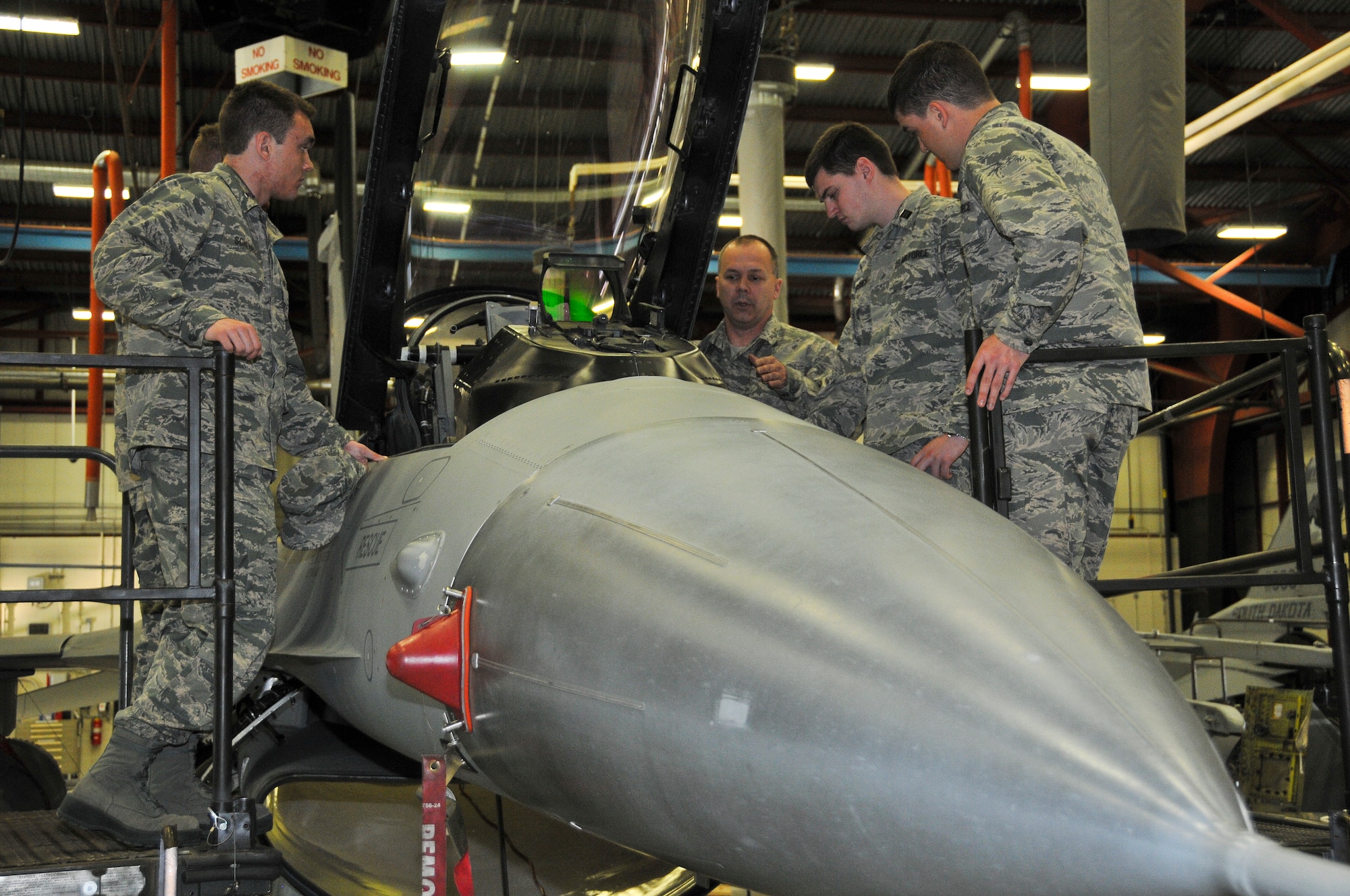 Master Sgt. Todd Panning, 114th Maintenance egress chief, showed the South Dakota State ROTC cadets different aspects of the pilot ejection (egress) system at Joe Foss Field, S.D., March 19, 2015. The students toured the 114th Fighter Wing and were briefed about the many roles and specialized fields that make up the South Dakota Air National Guard.(National Guard photo by Staff Sgt. Luke Olson/Released)