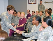 Maj. Gen. Jimmie Keenan, deputy commanding general (Operations), U.S. Army Medical
Command and chief, U.S. Army Nurse Corps, shakes hands with Airman 1st Class Tamara
Dawson Feb. 26 at the first “Sisters in Arms” meeting. Keenan talked about how important it is to connect with people and develop lasting relationships.
Photo by Lori Newman