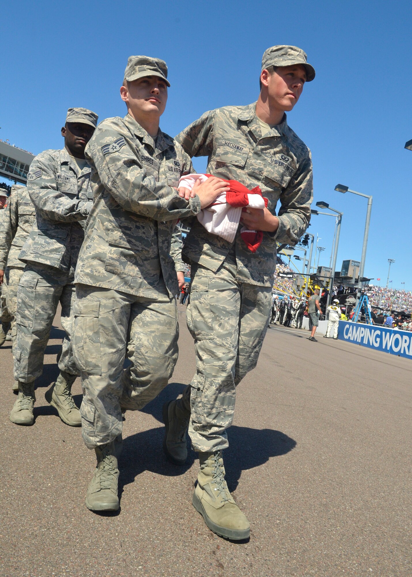 Luke Airmen carry the flag off the track at PIR. (U.S. Air Force photo/Senior Airman Devante Williams)