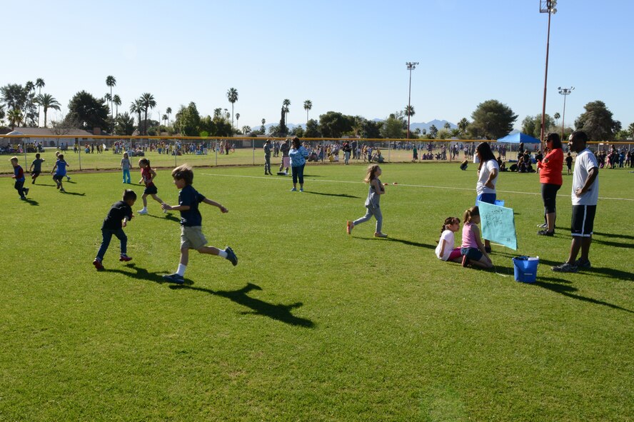 Airmen supervise students while they play tag during field day. More than 20 Airmen volunteered to help at the school event. (U.S. Air Force photo/Senior Airman James Hensley)