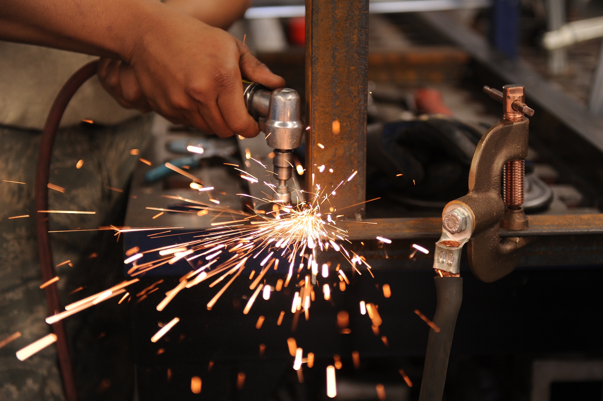 Senior Airman Caleb Wren, 4th Equipment Maintenance Squadron aircraft metals technology technician, grinds the joint of a gun tower March 10, 2015, at Seymour Johnson Air Force Base, North Carolina. Joints are initially tacked together by welding small, temporary beads where the two metal pieces connect. Once the frame is finally constructed, the temporary beads are ground down so a permanent seam can be applied. (U.S. Air Force photo/Airman 1st Class Aaron J. Jenne)