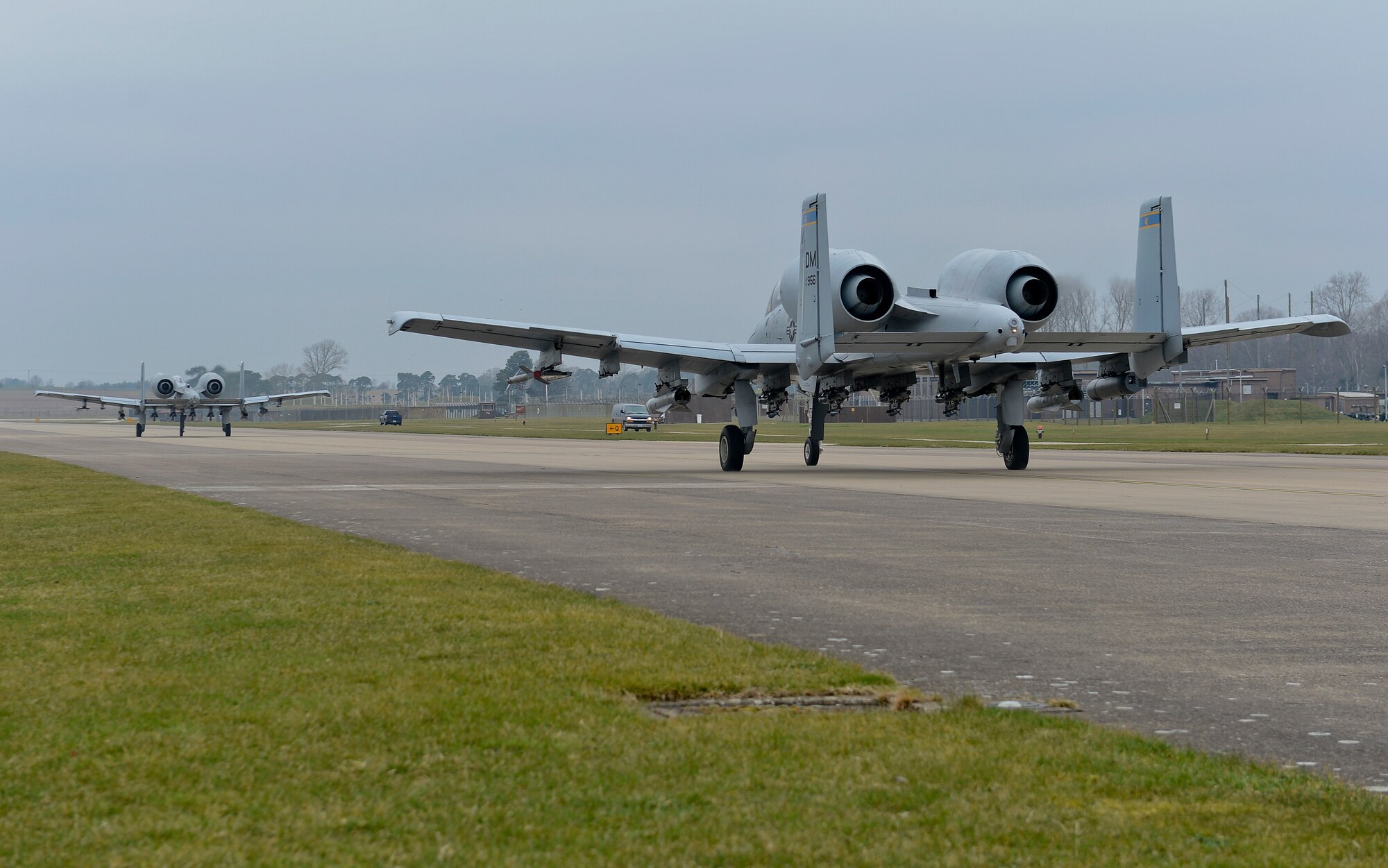 Two A-10C Thunderbolt IIs assigned to Davis Monthan Air Force Base, Ariz., taxi down the flightline at Royal Air Force Lakenheath, England, March 19, 2015. The A-10s and 354th Expeditionary Fighter Squadron Airmen are deployed as part of a Theater Security Package in support of Operation Atlantic Resolve. While visiting RAF Lakenheath for five days, they conducted training alongside NATO allies to strengthen interoperability and demonstrate U.S. commitment to the security and stability of Europe. (U.S. Air Force photo by Airman 1st Class Trevor T. McBride/Released)