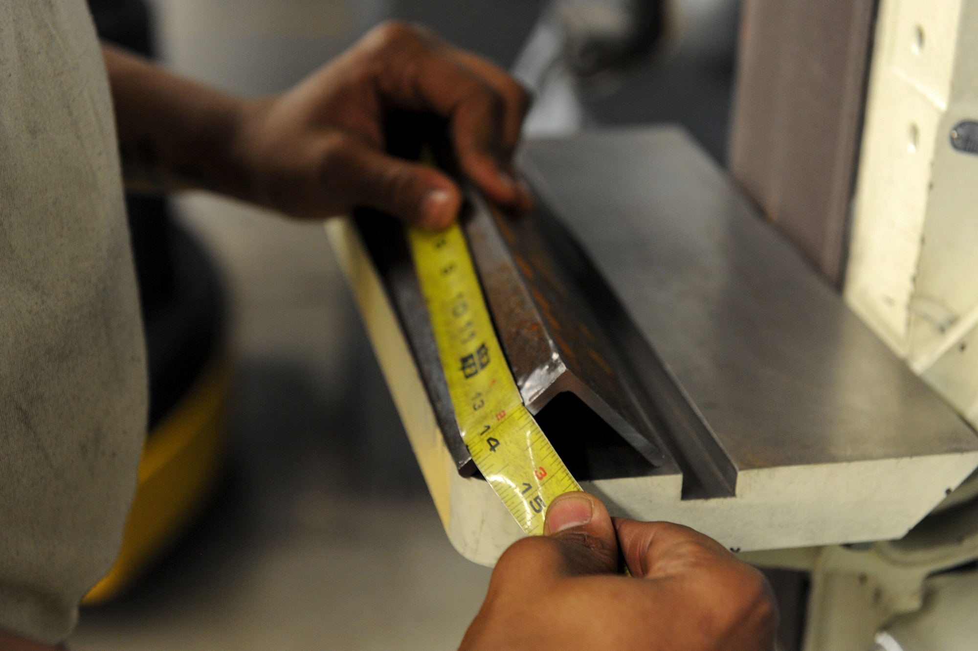 Senior Airman Caleb Wren, 4th Equipment Maintenance Squadron aircraft metals technology technician, measures a piece of angle iron March 10, 2015, at Seymour Johnson Air Force Base, North Carolina. Every cut made in the AMT shop requires precision and must fit the allowable tolerance in the blueprint. (U.S. Air Force photo/Airman 1st Class Aaron J. Jenne)