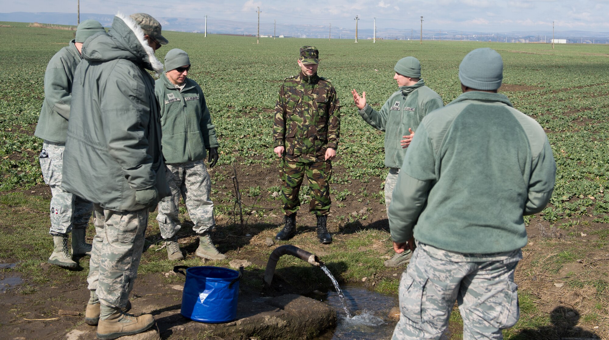 Air advisors from the 435th Air Ground Operations Wing discuss the local water source and methods to purify it near Campia Turzii, Romania, during Dacian Warhawk, a two-week training mission designed to increase the interoperability between the U.S. and Romanian allies March 19, 2015. The Airmen worked side-by-side to accomplish the bilateral training mission and also help out the local community. (U.S. Air Force photo/Staff Sgt. Armando A. Schwier-Morales)
