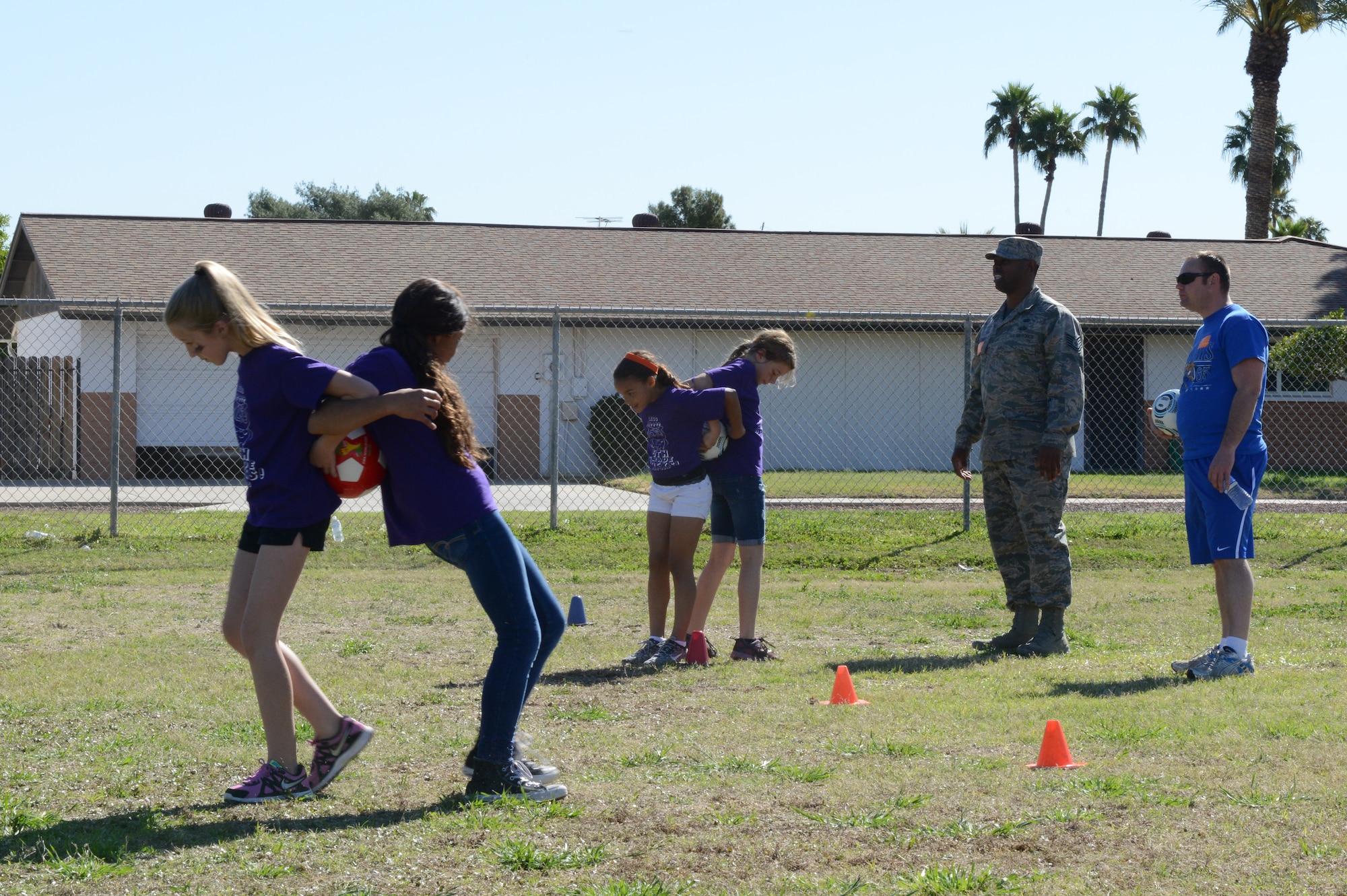 Tech. Sgt. Douglas Schmidt, 56th CONS Plans Programs Flight NCO in charge, watches over students during the soccer ball walk. (U.S. Air Force photo/Senior Airman James Hensley)