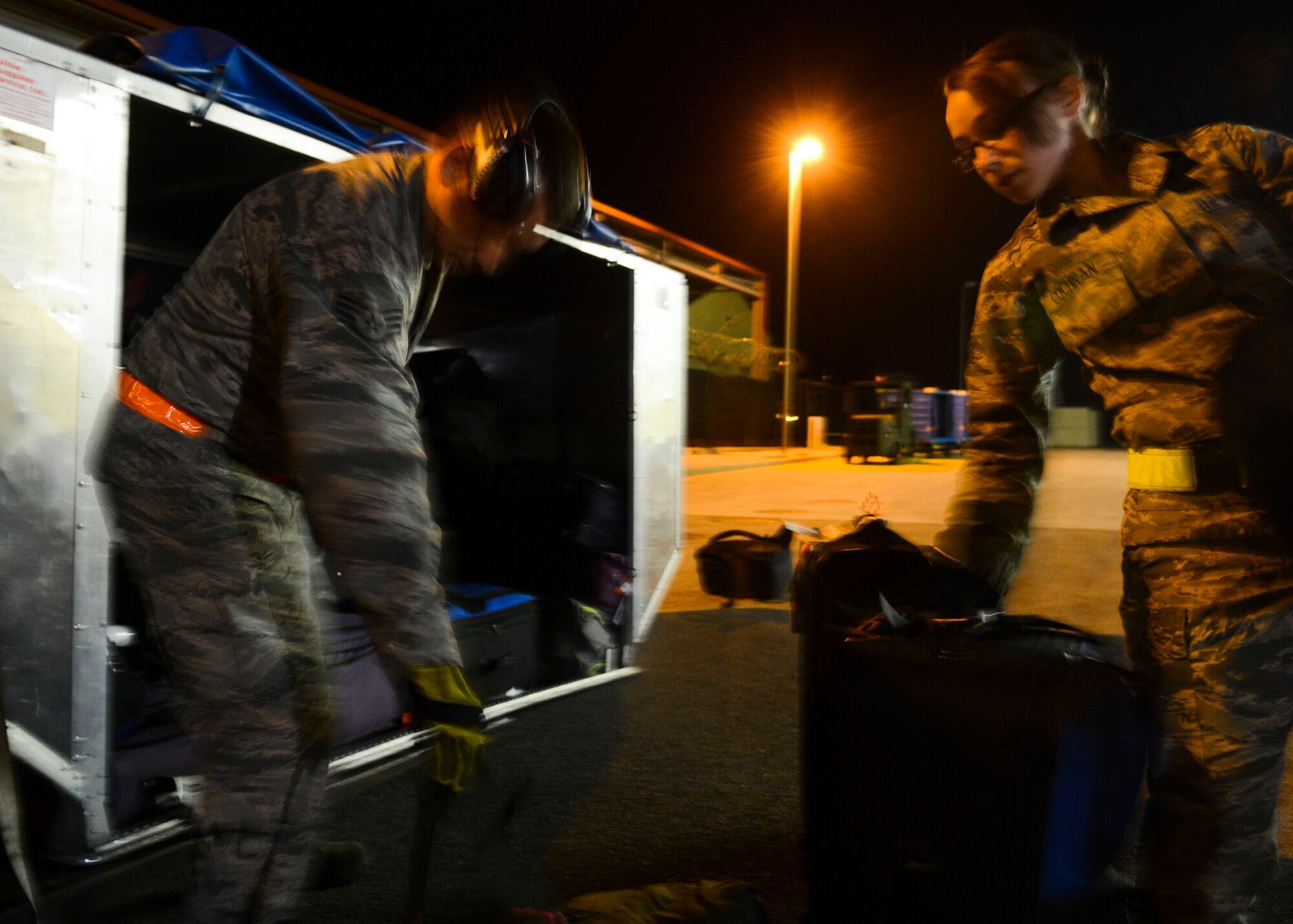 U.S. Air Force Airmen with the 724th Air Mobility Squadron unload luggage at Aviano Air Base, Italy, March 17, 2015. The weekly rotator utilizes every asset of the AMS and is one of the most visible examples of the squadron’s mission. (U.S. Air Force photo by Senior Airman Austin Harvill/Released)