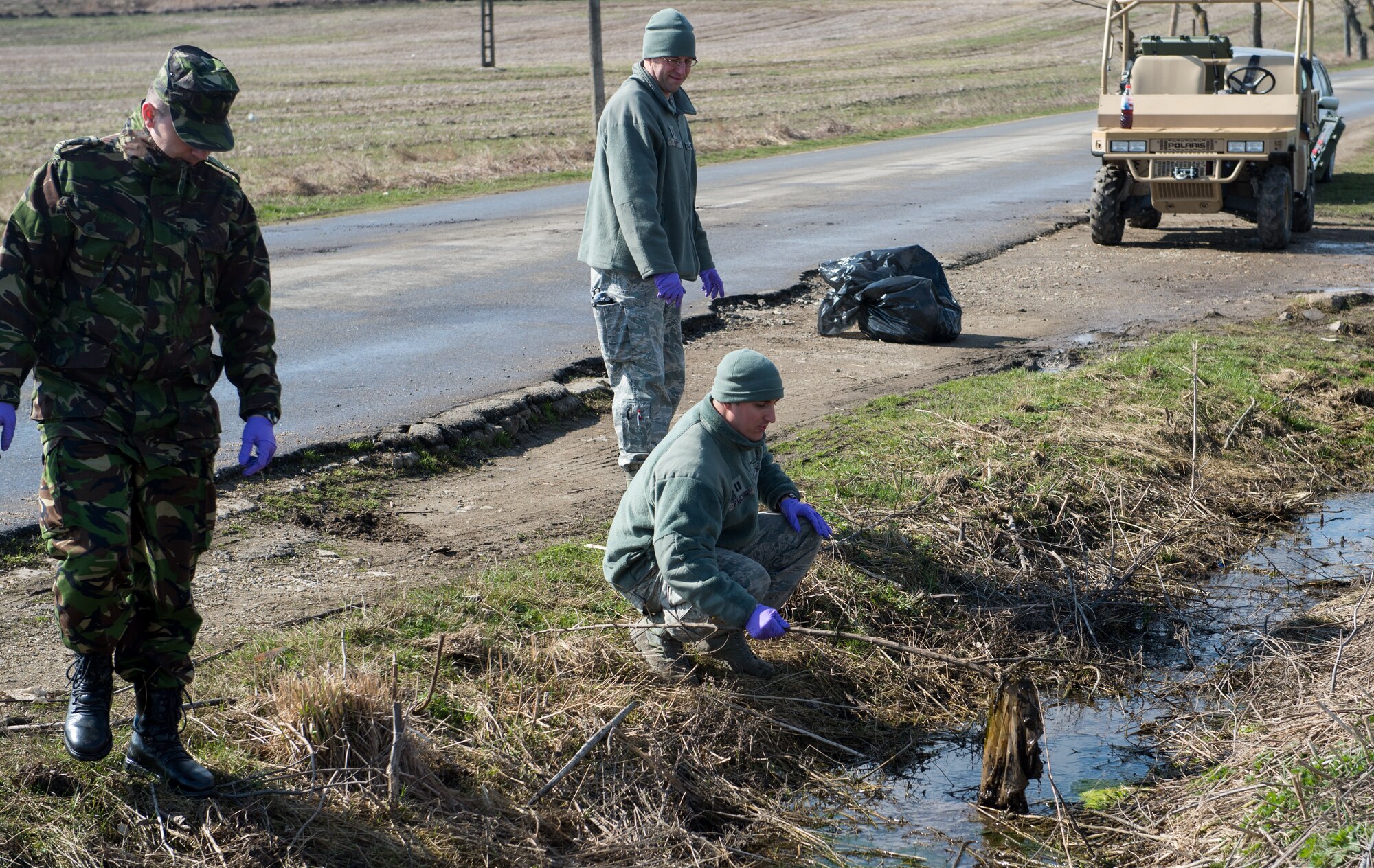 U.S. and Romanian Airmen clean a water source used by the local community near Campia, Turzii, Romania, during Dacian Warhawk, a two-week training mission designed to increase the interoperability between the U.S. and Romanian allies March 19, 2015. The Airmen worked side-by-side to accomplish the bilateral training mission and also help out the local community. (U.S. Air Force photo/Staff Sgt. Armando A. Schwier-Morales)