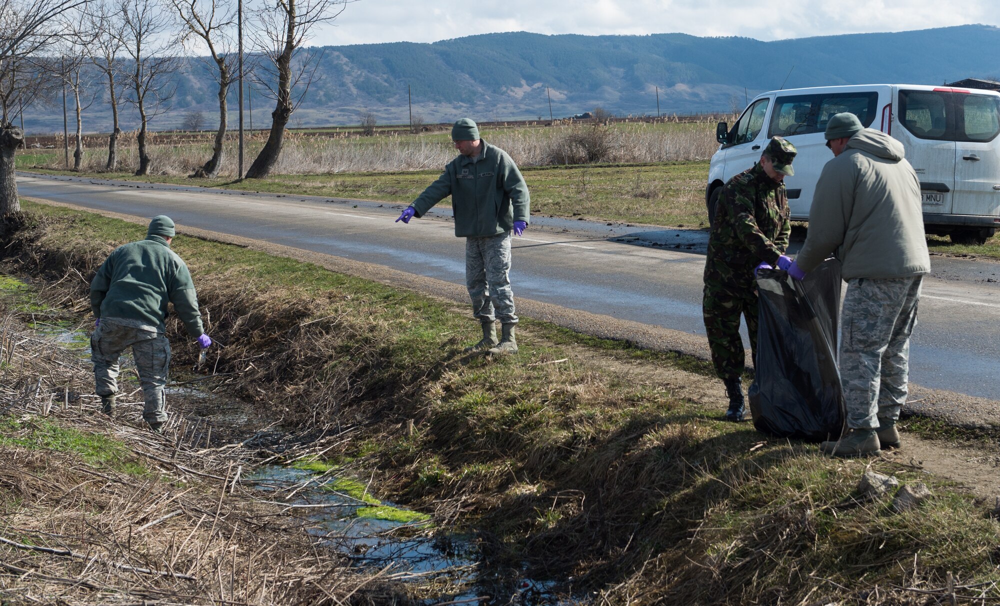 Tech Sgt. Timothy Hoffma, Det. 1, 435th Contingency Response Group bioenvironmental technician, cleans an area near Campia Turzii, Romania, during Dacian Warhawk, a two-week training mission designed to increase the interoperability between the U.S. and Romanian allies March 19, 2015. During their spare time, the Airmen found ways to give back to the local community. (U.S. Air Force photo/Staff Sgt. Armando A. Schwier-Morales)