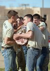 University of New Mexico's Air Force Reserve Officer Training Corps members struggle to carry a log at Kirtland March 4 during a leadership training laboratory. (Photo by Jamie Burnett)
