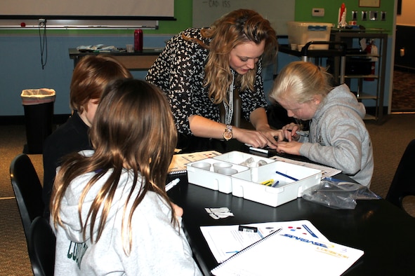 Jackie Hopkins works with students during a lesson at STARBASE at Selfridge Air National Guard Base, Mich., March 12, 2015. Hopkins is a student majoring in education at Oakland University. STARBASE recently launched a new partnership with OU to provide opportunities for education students at OU to spend several days working in STARBASE classrooms. Some 1,800 children per year – primarily in 5th grade – spend five days at STARBASE learning about science, technology, engineering and math. (U.S. Air National Guard photo by Tech. Sgt. Dan Heaton)