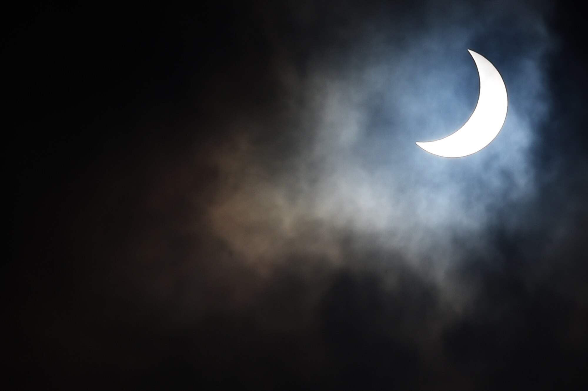 The moon moves past its position between the sun and the Earth at 9:54 a.m. during a solar eclipse, visible from RAF Alconbury, England, March 20, 2015. Due to cloud coverage, many UK residents were not able to witness the eclipse. (U.S. Air Force photo by Staff Sgt. Jarad A. Denton/Released)