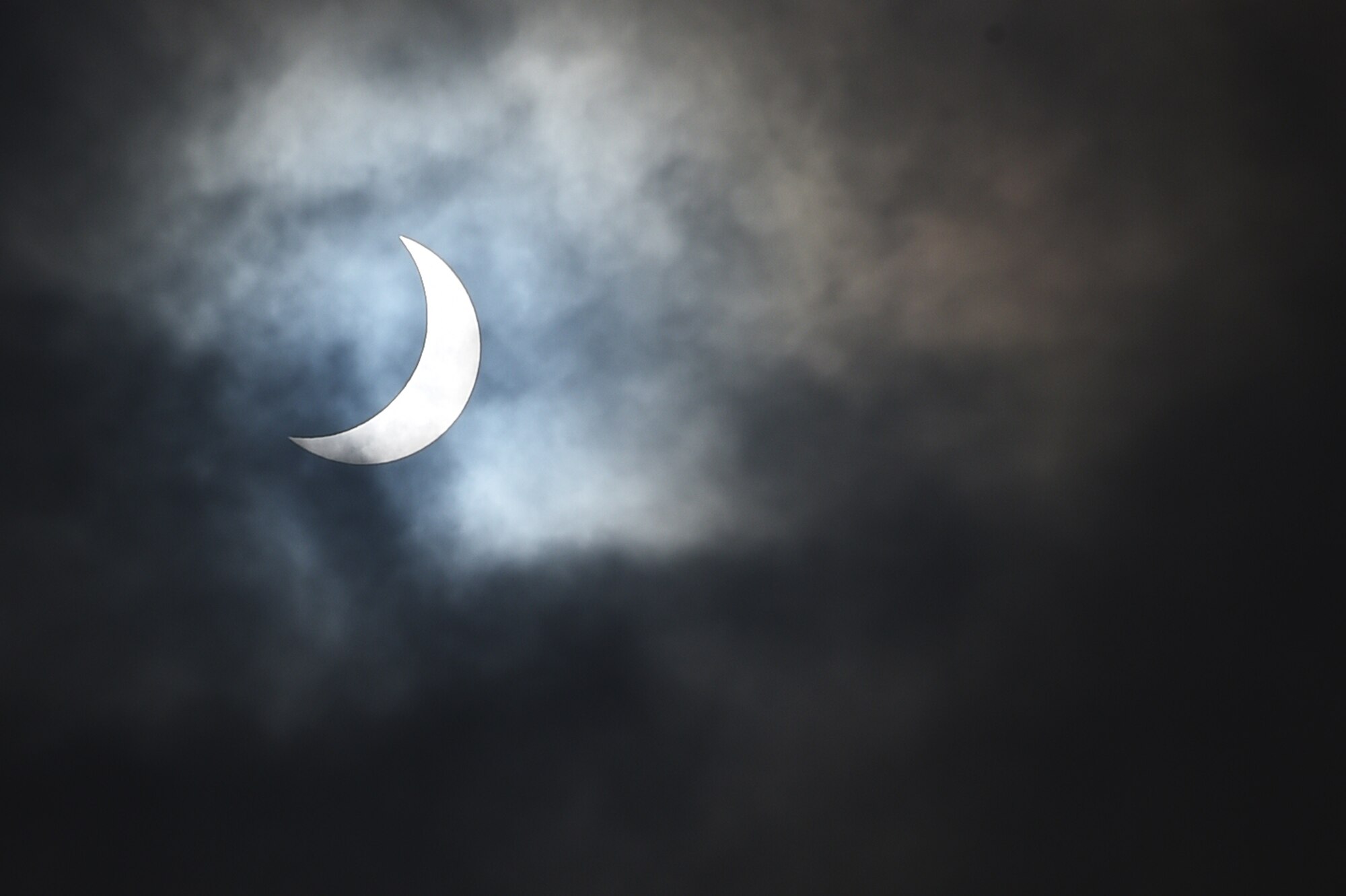 The moon moves past its position between the sun and the Earth at 9:52 a.m. during a solar eclipse, visible from RAF Alconbury, England, March 20, 2015. Due to cloud coverage, many UK residents were not able to witness the eclipse. (U.S. Air Force photo by Staff Sgt. Jarad A. Denton/Released) 