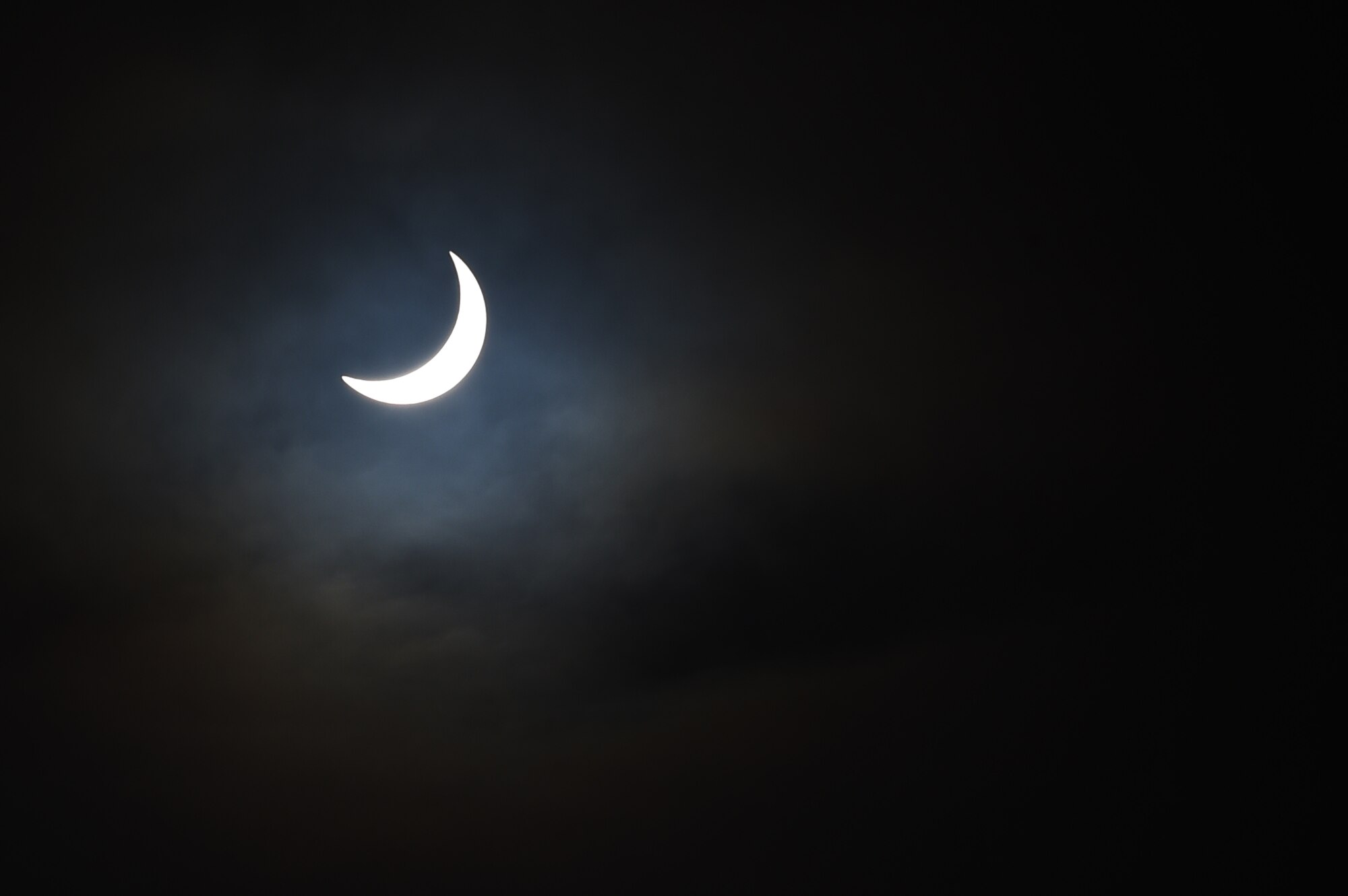 The moon moves past its position between the sun and the Earth at 9:46 a.m. during a solar eclipse, visible from RAF Alconbury, England, March 20, 2015. The exact moment of greatest darkness in the United Kingdom varied based on the observer’s location. (U.S. Air Force photo by Staff Sgt. Jarad A. Denton/Released)