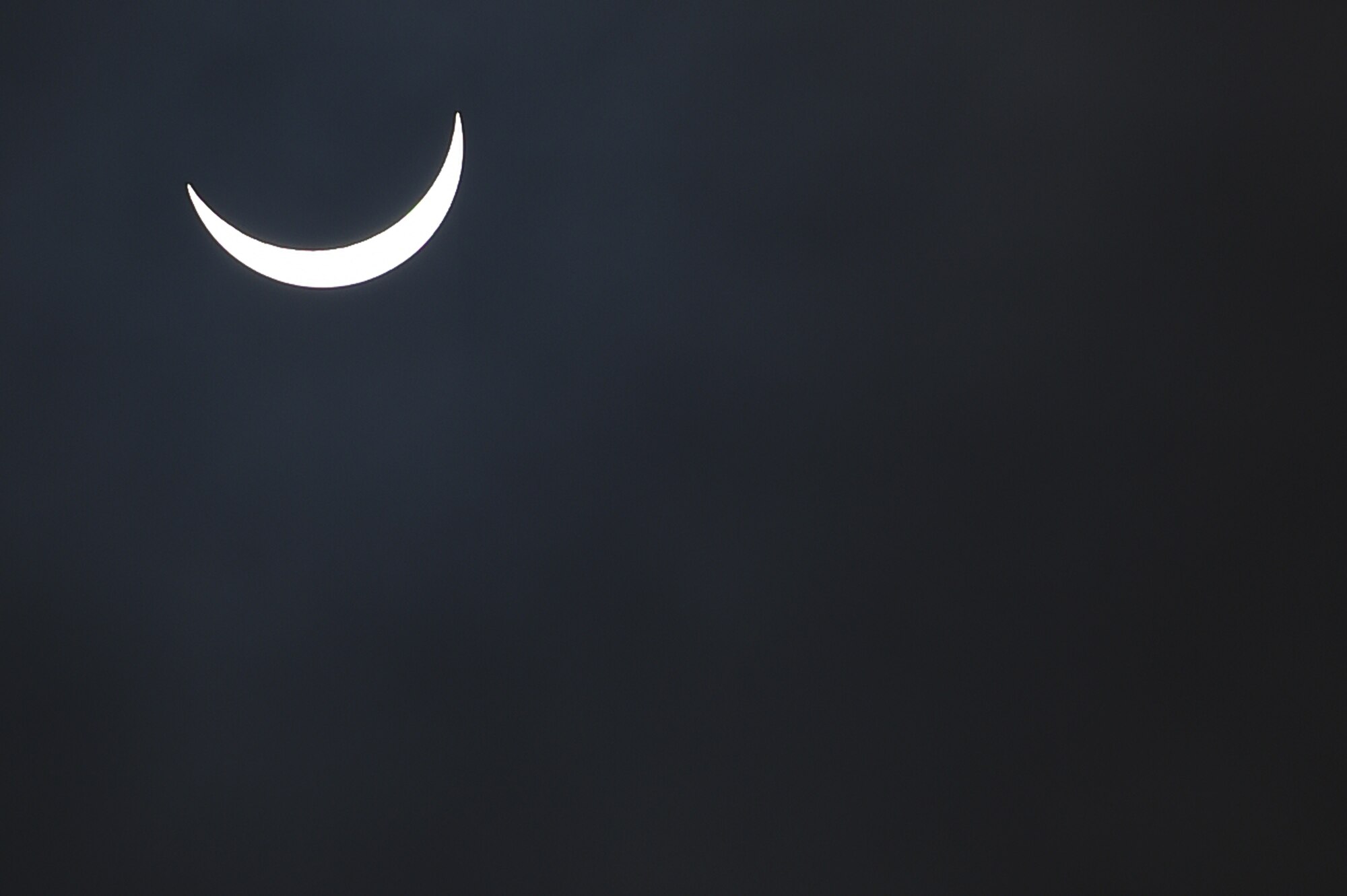 The moon moves past its position between the sun and the Earth at 9:38 a.m. during a solar eclipse, visible from RAF Alconbury, England, March 20, 2015. During this eclipse, only part of the sun was obscured. (U.S. Air Force photo by Staff Sgt. Jarad A. Denton/Released)