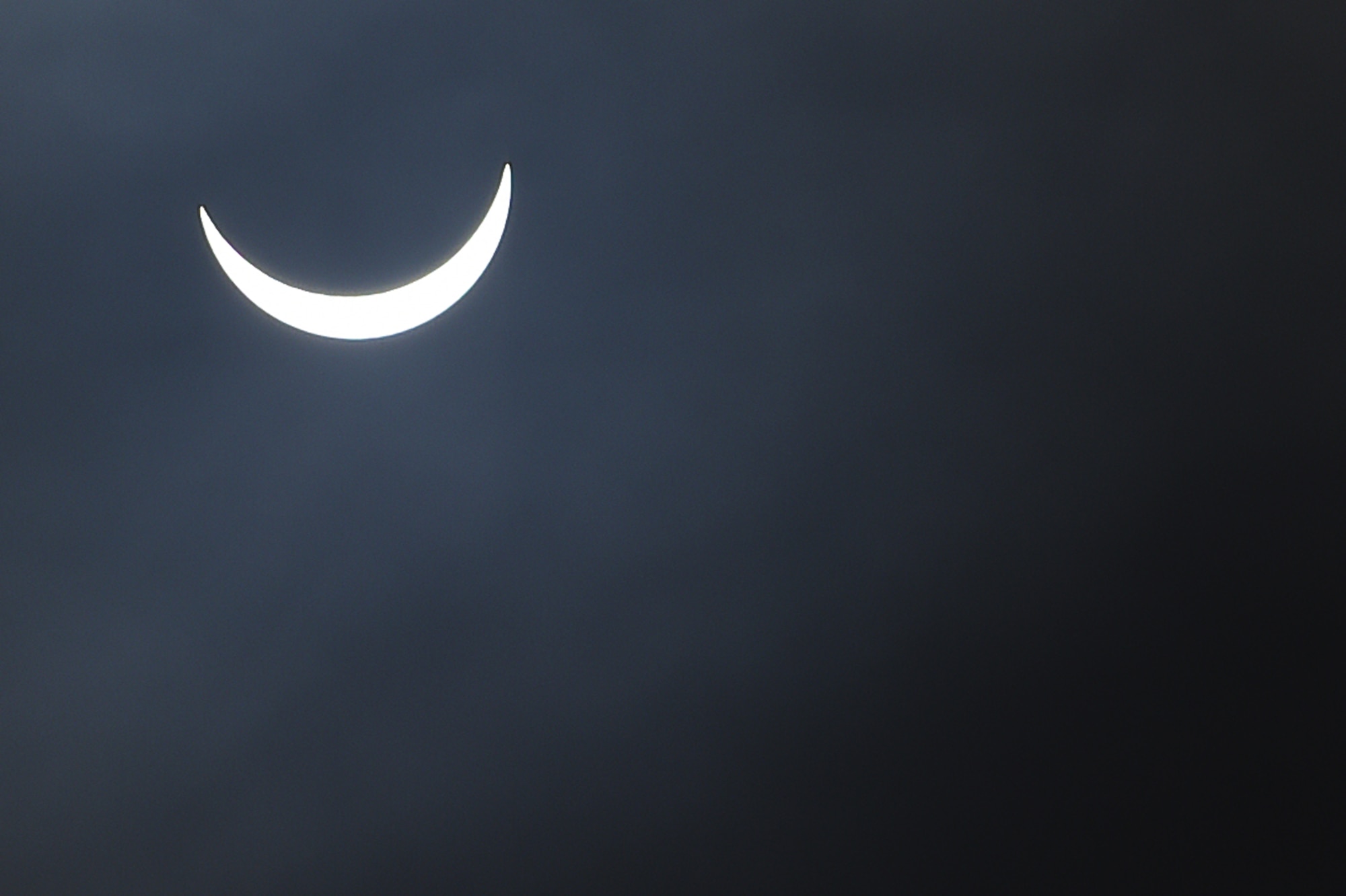 The moon moves past its position between the sun and the Earth at 9:37 a.m. during a solar eclipse, visible from RAF Alconbury, England, March 20, 2015. During this eclipse, only part of the sun was obscured. (U.S. Air Force photo by Staff Sgt. Jarad A. Denton/Released)