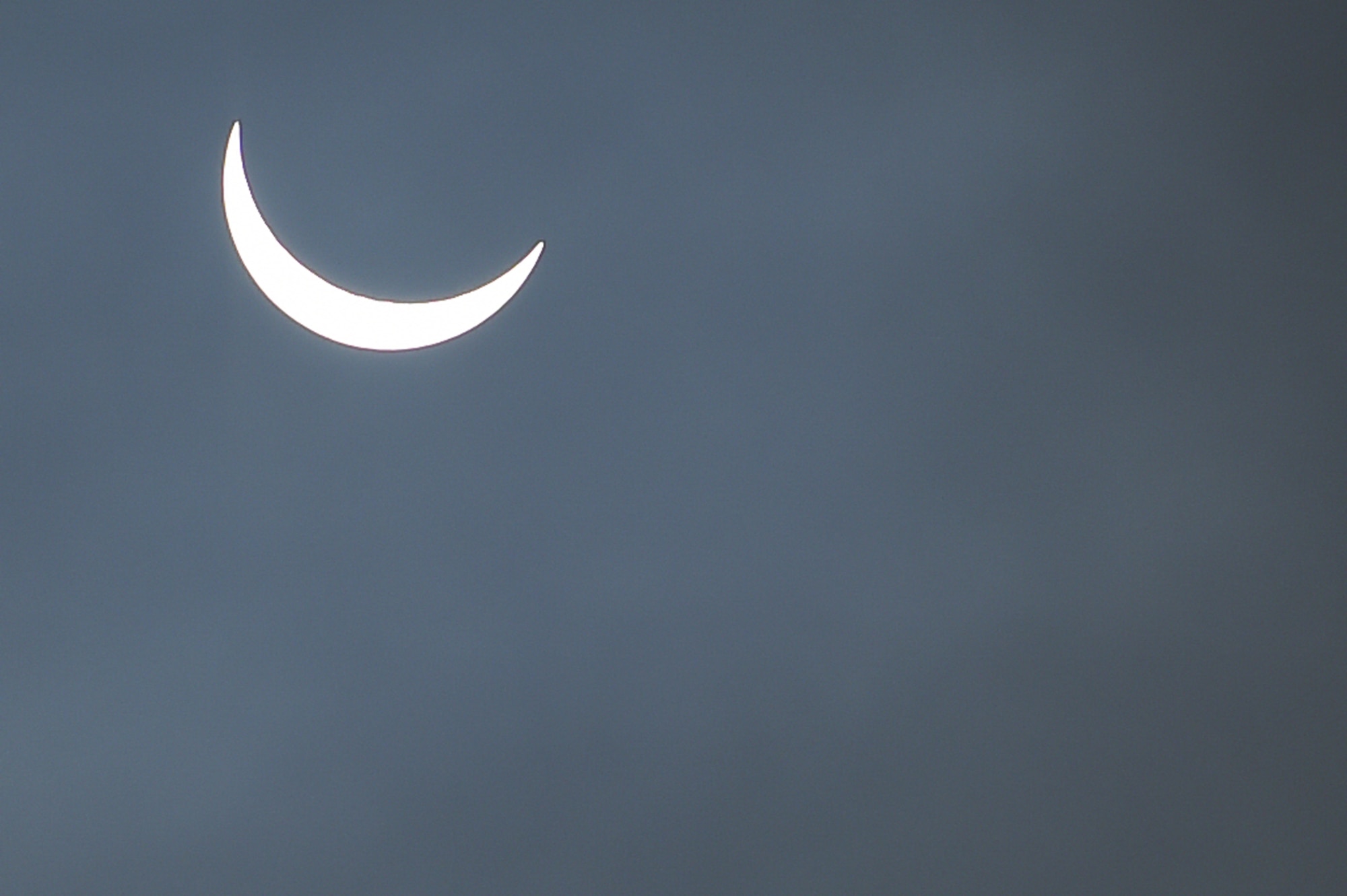 The moon continues its pass between the sun and the Earth at 9:31 a.m. during a solar eclipse, visible from RAF Alconbury, England, March 20, 2015. An 83 percent eclipse was visible throughout the entire United Kingdom. (U.S. Air Force photo by Staff Sgt. Jarad A. Denton/Released)