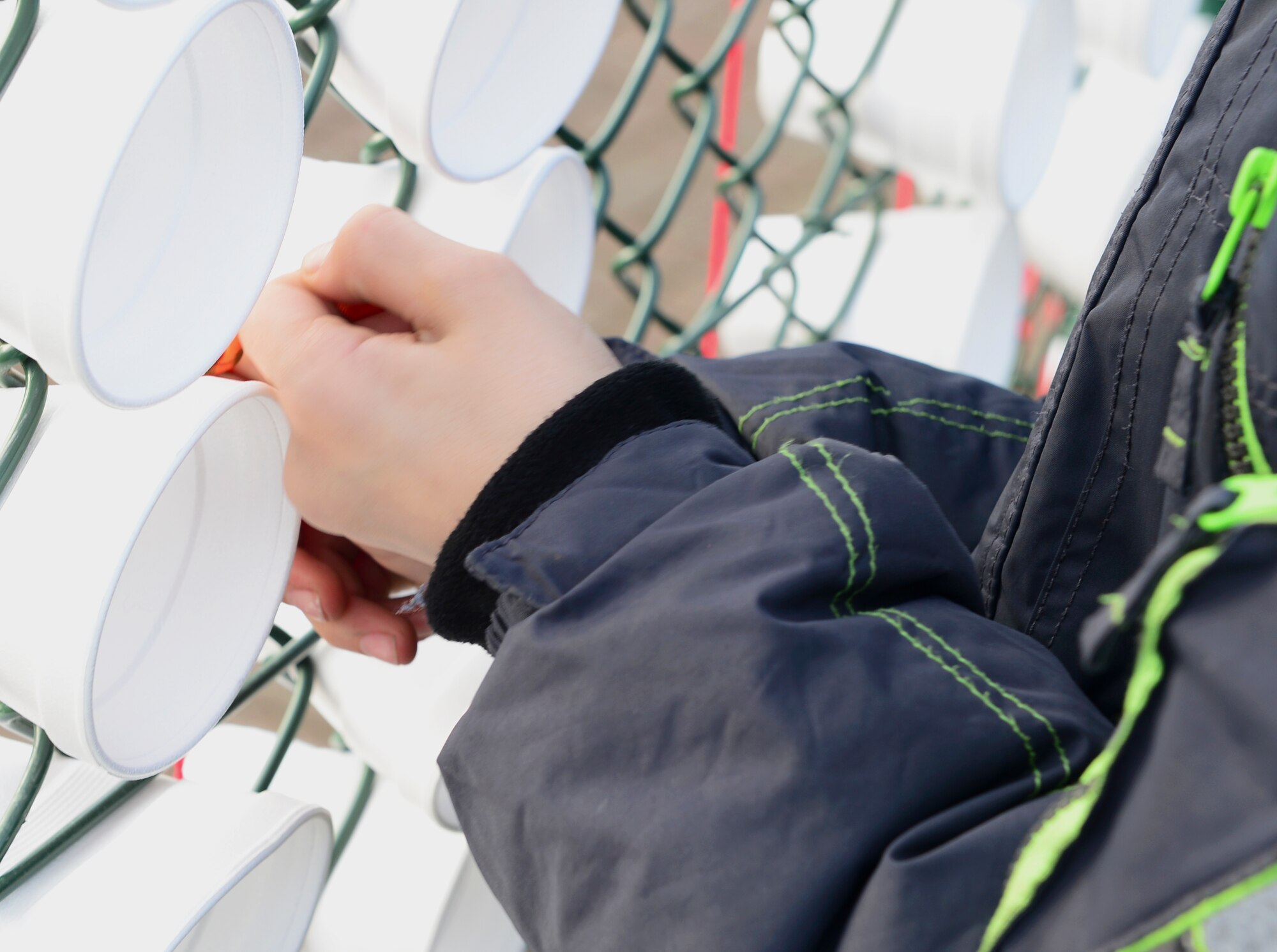 Jacob Trower, 10-year-old, son of Staff Sgt. Thomas Trower, 48th Fighter Wing Public Affairs, ties a pledge ribbon to the fence of the youth center at Royal Air Force Lakenheath, England, March 18, 2015. Children participated in various activities in the “Just Say No” campaign, pledging to be tobacco free. (U.S. Air Force photo by Airman 1st Class Dawn M. Weber/Released)