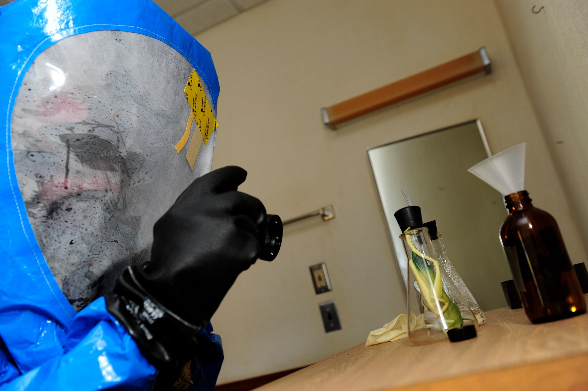 U.S. Air Force Airman 1st Class Joseph Jordan, 18th Civil Engineer Squadron emergency management technician, takes a picture of staged unknown chemicals during an Integrated Base Emergency Response Capabilities Training exercise March 18, 2015, on Kadena Air Base, Japan. The pictures are for preserving evidence for investigative purposes. (U.S. Air Force photo by Airman 1st Class John Linzmeier)
