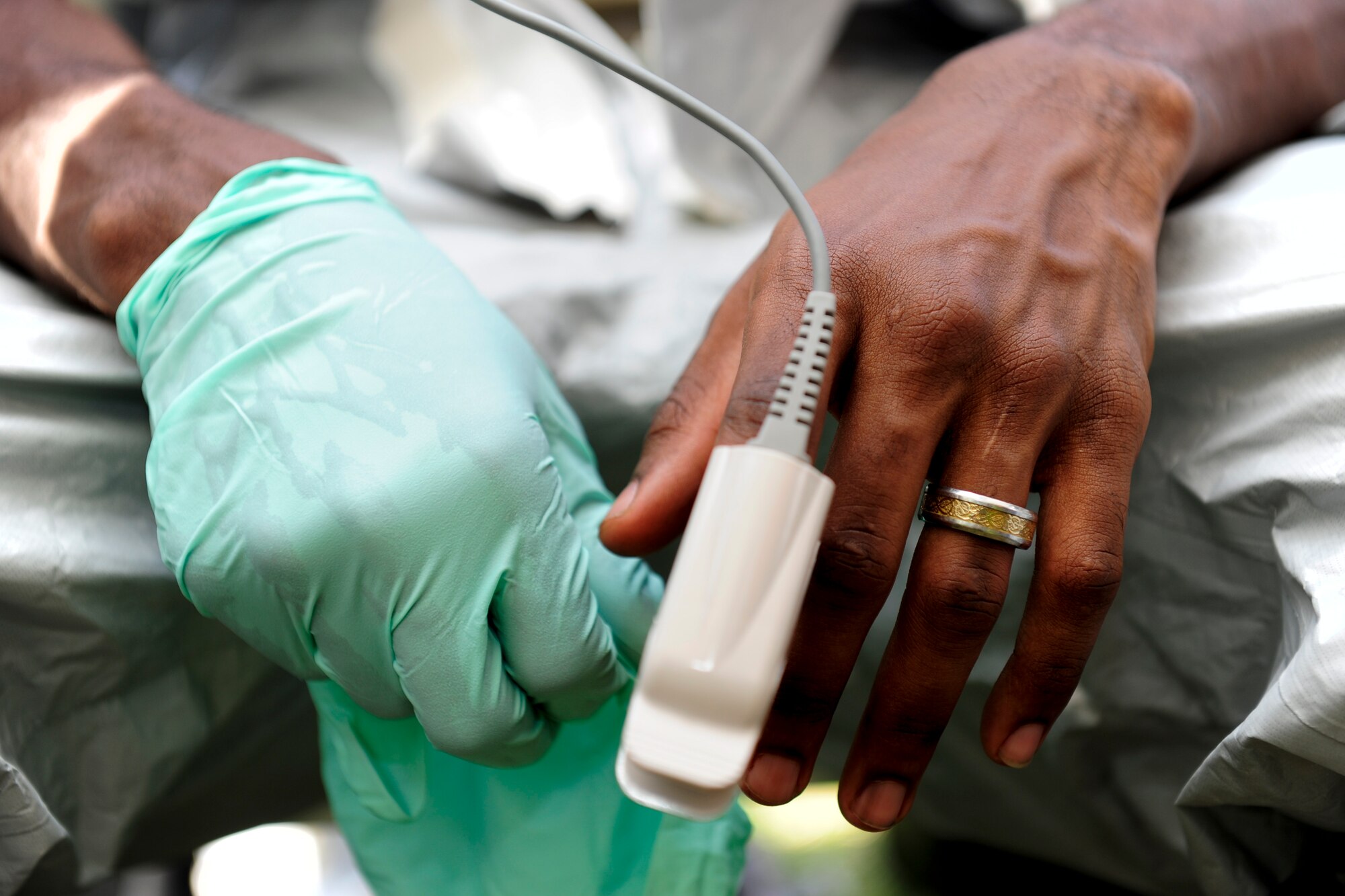 U.S. Air Force Airman 1st Class Isaiah Flemings, 18th Aerospace Medicine Squadron bioenvironmental engineering technician, has his vitals checked before suiting into personal protective gear during an Integrated Base Emergency Response Capabilities Training exercise March 18, 2015, on Kadena Air Base, Japan.  Vitals are checked before performing in personal protective gear in order to ensure the user is fit for the physical demands of performing duties in the suit, and a post assessment is conducted to detect if a health concern arose from the labor. (U.S. Air Force photo by Airman 1st Class John Linzmeier)