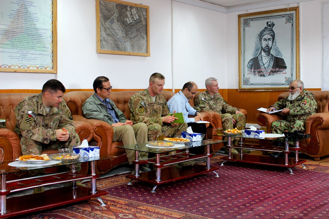 U.S. Army Maj. Gen. Mike Murray, second from right, deputy commander, U.S. Forces Afghanistan Support, meets with Afghan Maj. Gen. Gullam Farouq, commanding general, Military Police Guard, to discuss the future of the National Security Justice Development facility in Parwan province, Afghanistan, March 11, 2015.